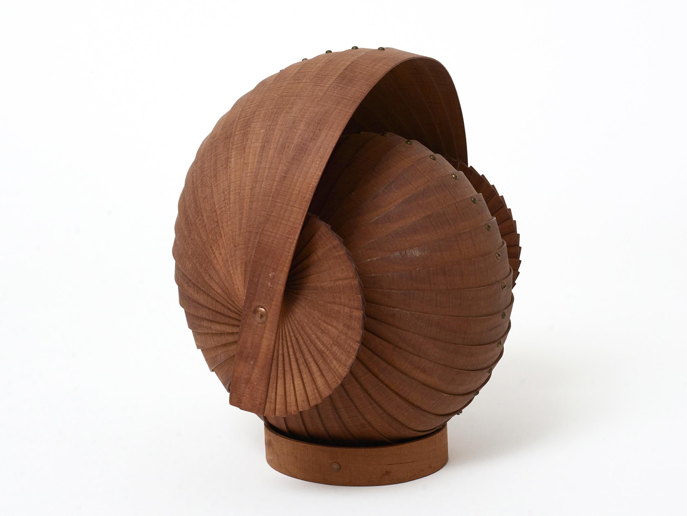 A beautifully made bentwood head or nautilus form sculpture with brass screws and copper rivets. Found in France and probably from the 1970s. Sits on an oval base and shows well in multiple positions. Some water marks on the base and small scuffs on