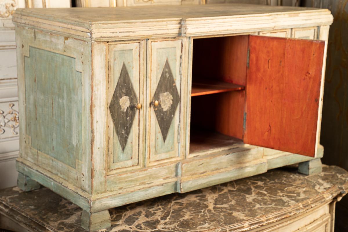 This is a beautifully painted coffee table/storage trunk that can be used multiple ways. It is decorated with neoclassical figures. Because of the height it can be used as a bench,a storage trunk or a coffee table. It also would be charming in a