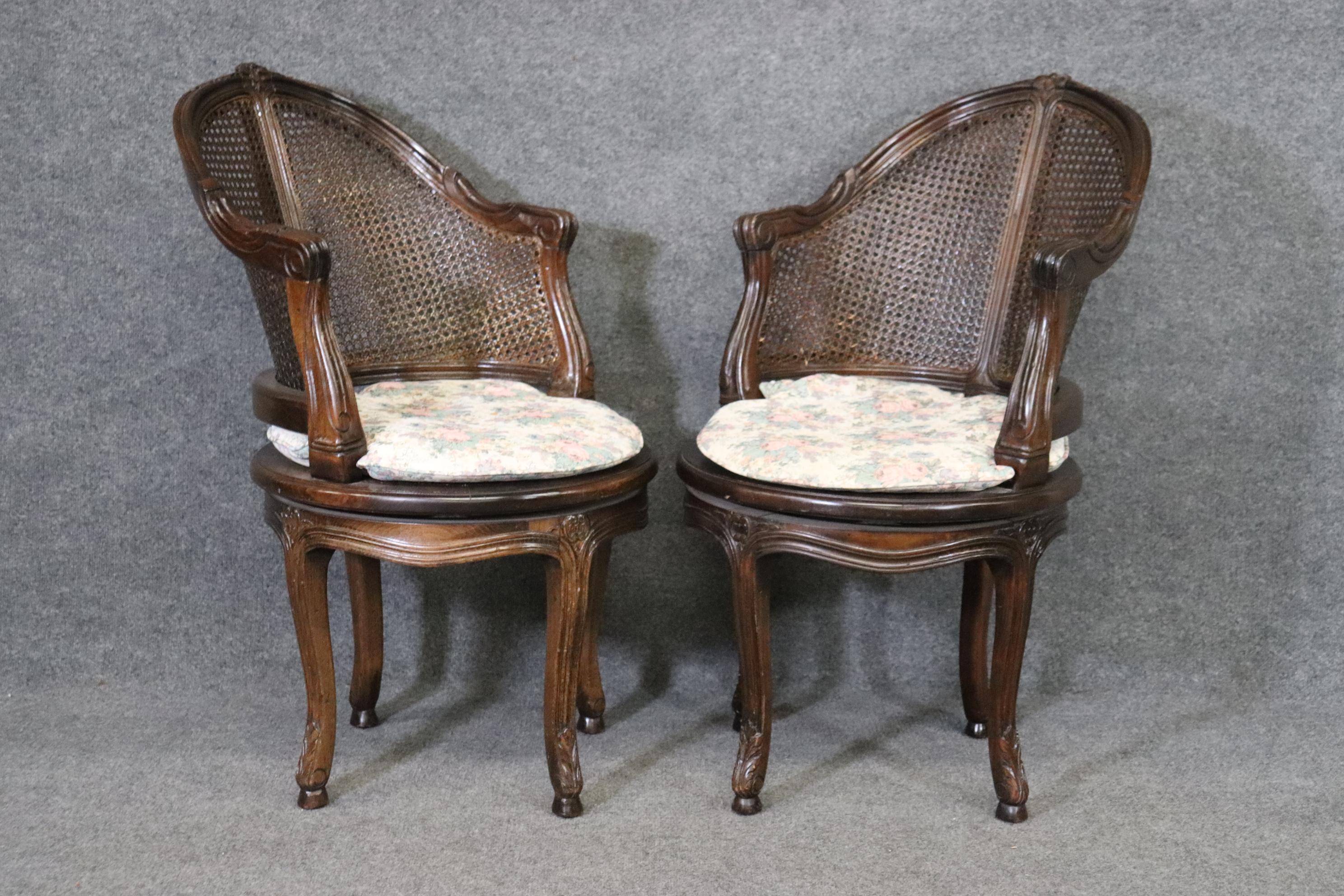 This is a beautiful pair of 1930-40s era swiveling corner chairs in the Louis XV style. The chairs are in good vintageb condition and may have some small losses to the finish on the cane but no damages that I can finid to the actual cane surfaces.