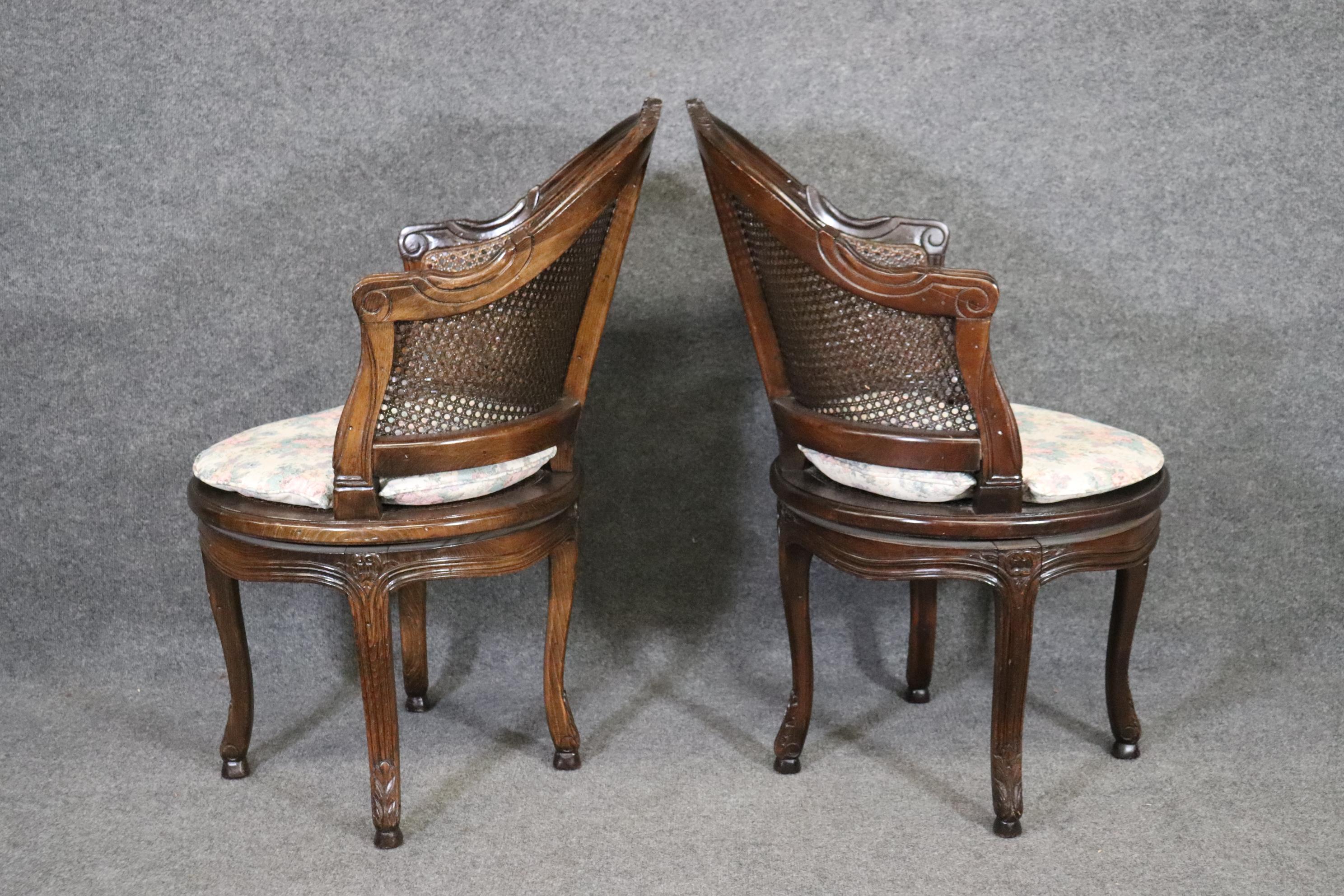 Mid-20th Century Beautifully Pair of Dark Walnut Cane back and Seated Swiveling Corner Chairs