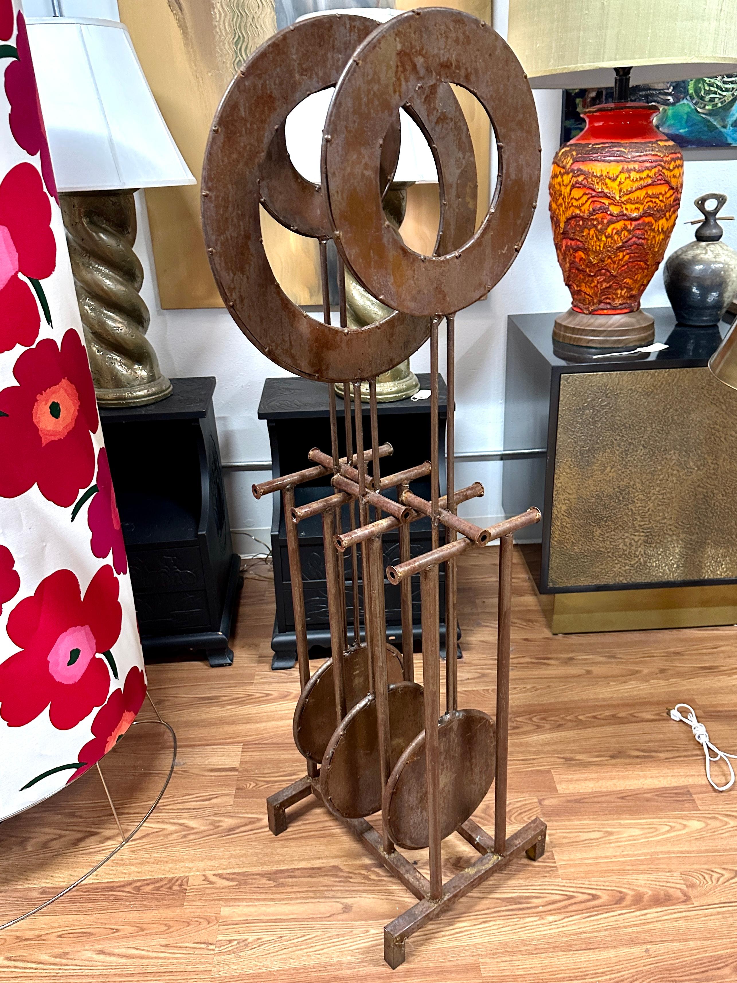 A wonderful Kinetic sculpture out of iron that has rusted to a beautiful patina. Works nicely, please see the attached video. Large and impressive, it will make a welcme addition to your garden or courtyard. Nicely spot welded discs attached to a