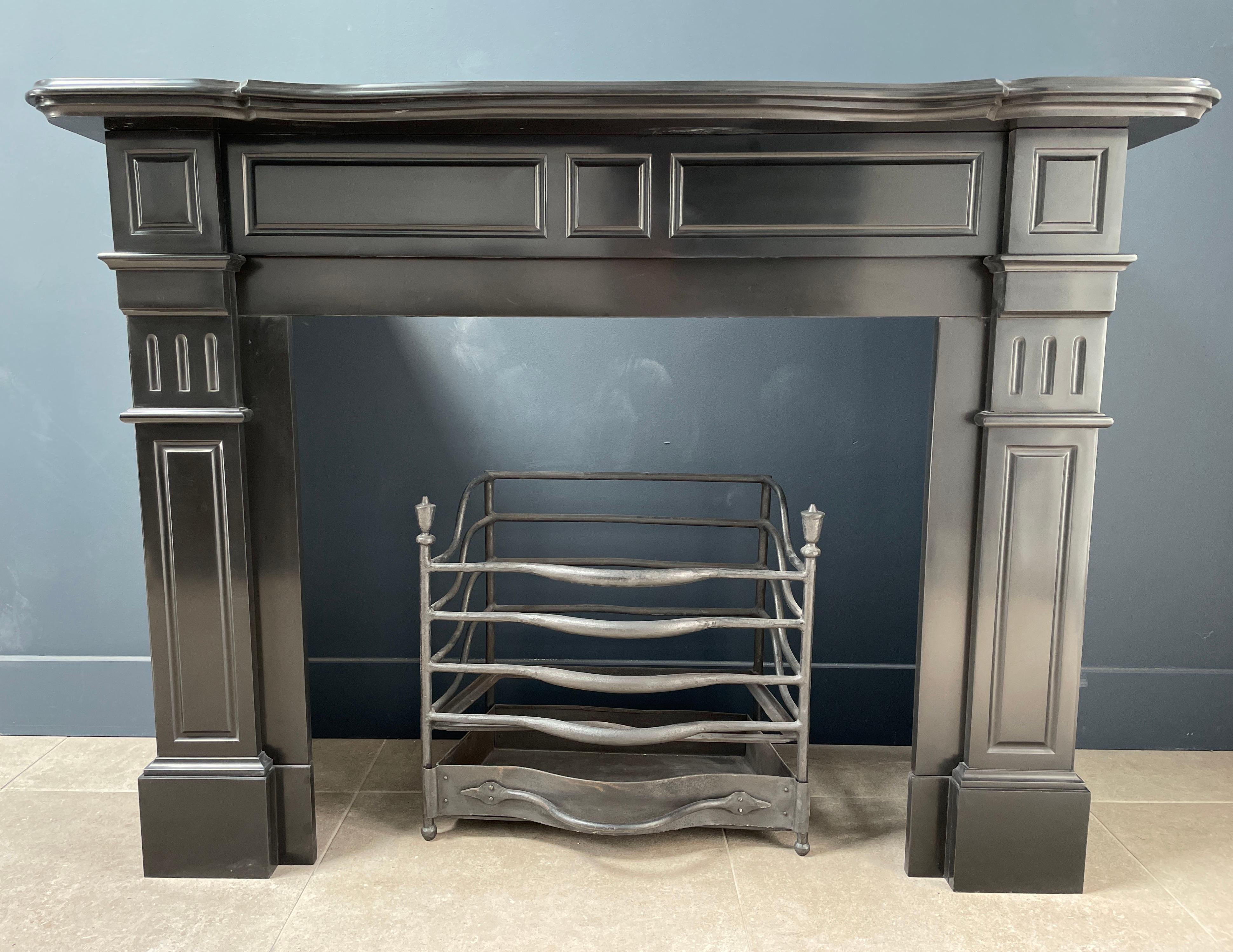 Beautifully Restored Antique Black circular fireplace. With its clean lines and deep shine, this fireplace is a top piece. The clean lines of the consoles are provided by the milling in the front. This fireplace has an extra luxurious top which, in