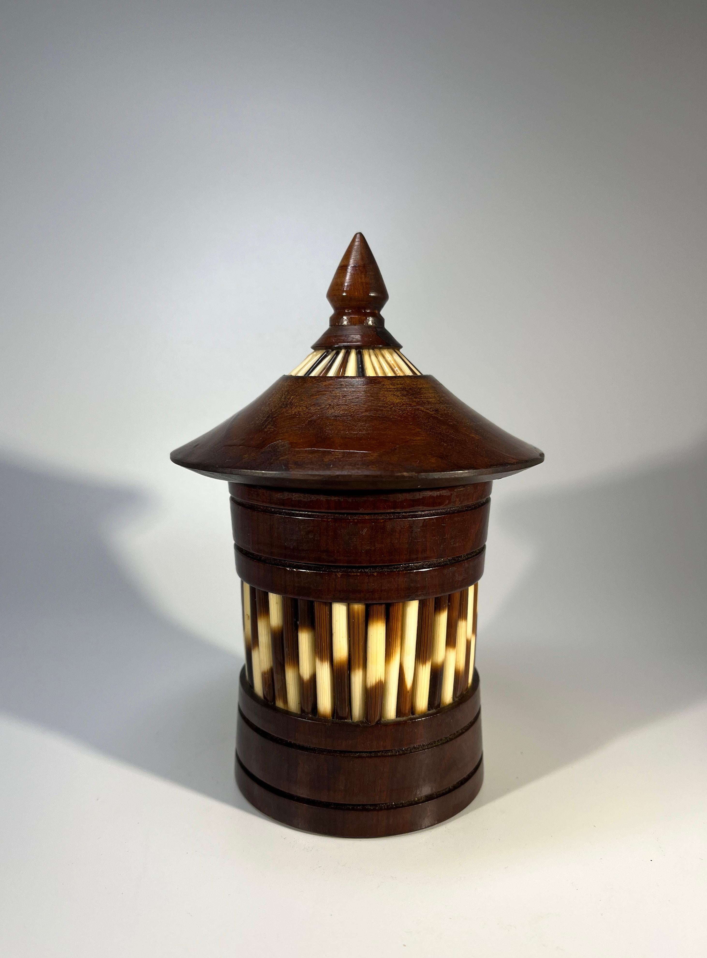 Superb Ceylonese porcupine quill lidded pot in a most unusual conical shape 
Fashioned in dark wood and decorated with quill pieces
All quills are present and in excellent order. Interior appears unused
Circa 1950
Height 6.25 inch, Diameter 4