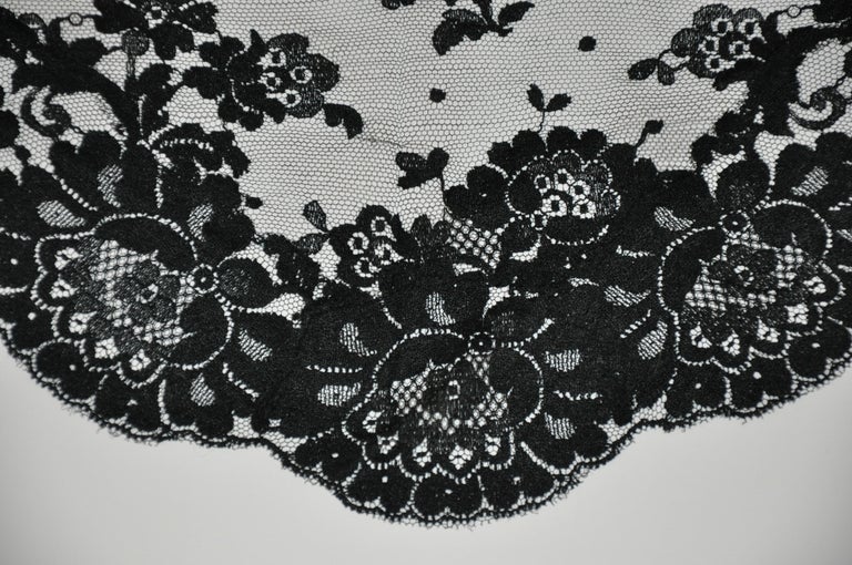     This beautifully thick midnight black bold floral netted scarf is accented with large scalloped edges and measures 45 inches by 30 inches by 30 inches. Made in Italy.
