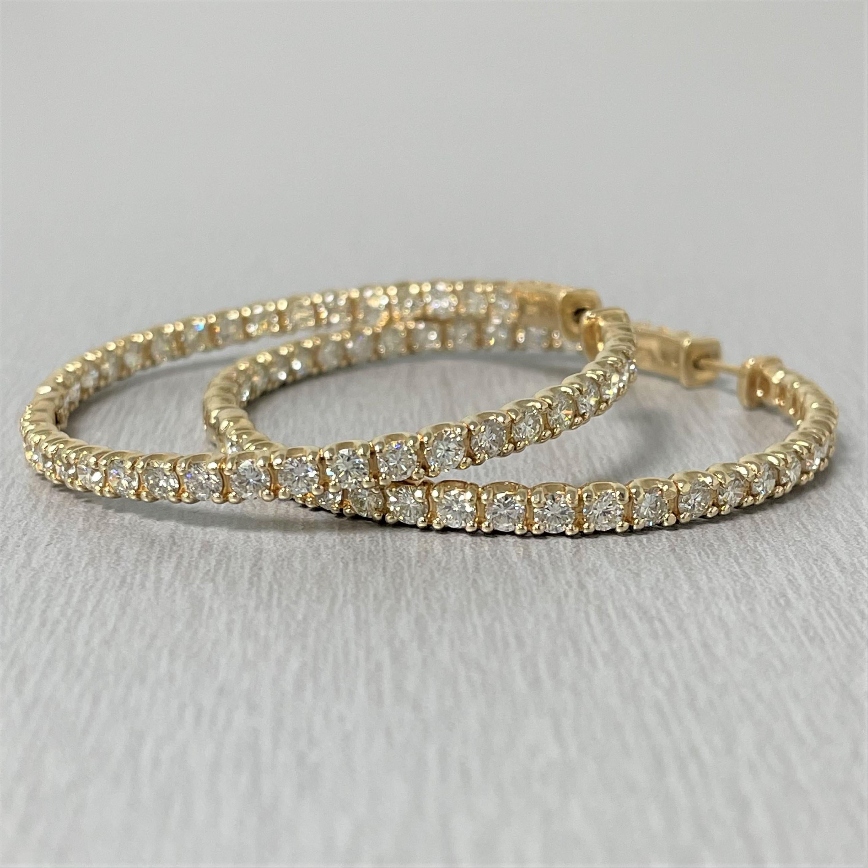 Chic and suave, diamond hoop earrings are forever stylish and fun. 

Diamond Shape: Round 
Total Diamond Weight: 6.19 ct 
Average Diamond Size: 0.08 ct 
Diamonds Color: I - J 
Diamonds Clarity: VS (Very Slightly Included) 

Metal: 14K Yellow Gold