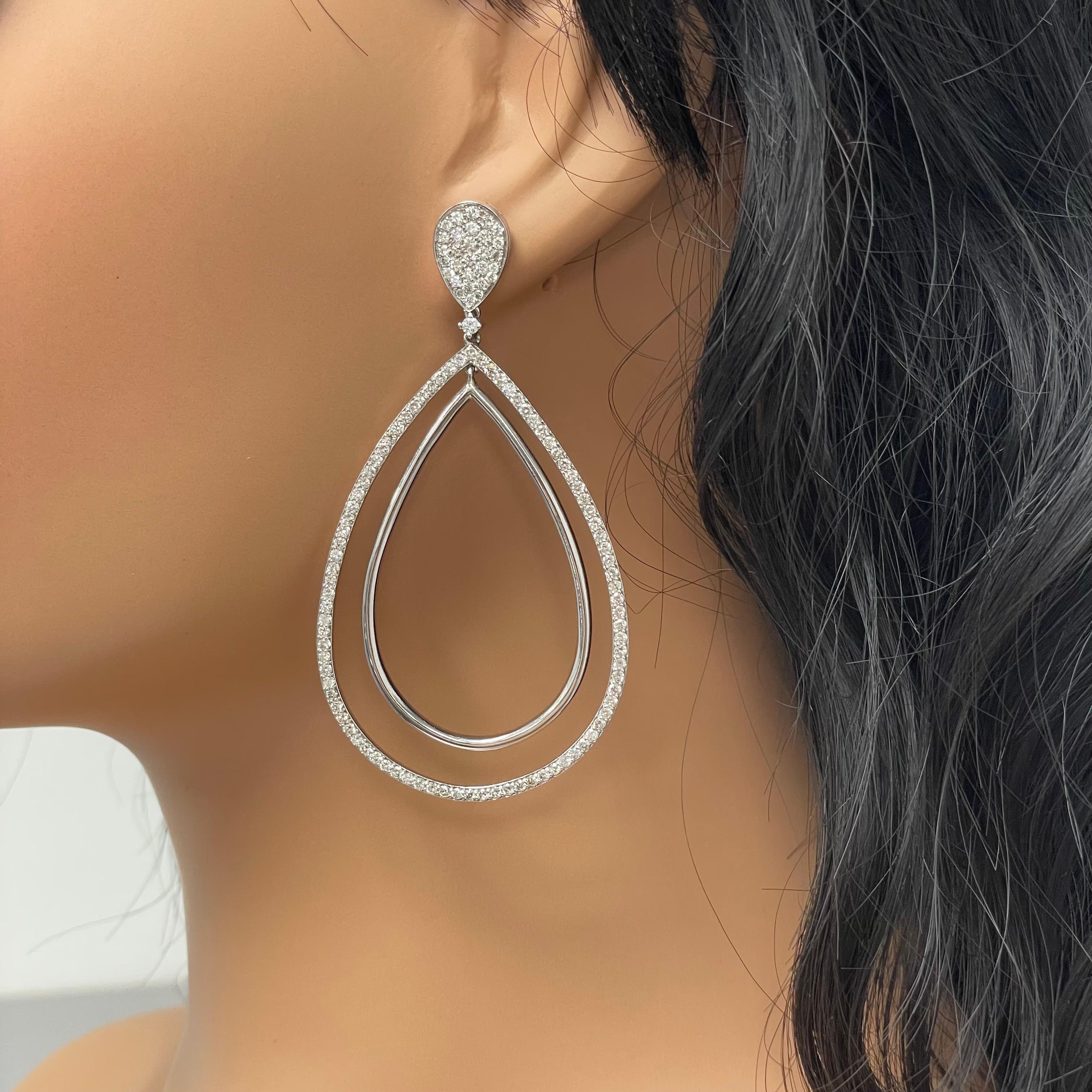 Hip, cool, chic and fun are the best words to describe these large diamond earrings.

Diamonds Shape: Round
Side Diamonds Weight: 4.25 ct
Side Diamond Color: G - H
Side Diamond Clarity: VS - SI

Metal: 14K White Gold
Metal Wt: 19.12 gms 
Setting: