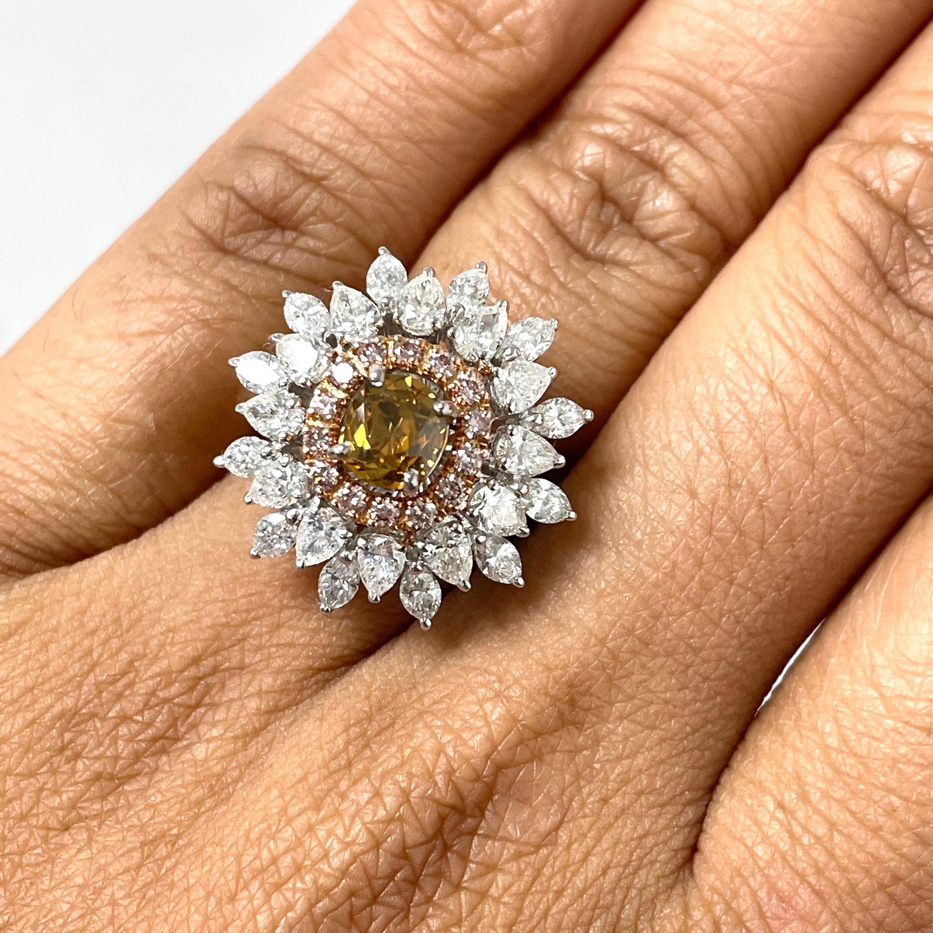 The Blossoms Diamond Cocktail Ring is uniquely floral and dazzling. With a orangey brown diamond center and a pink diamond halo, all surrounded with marquise and pear shape diamond radiating outwards, the ring is a mesmerizing jewel.

Center Diamond