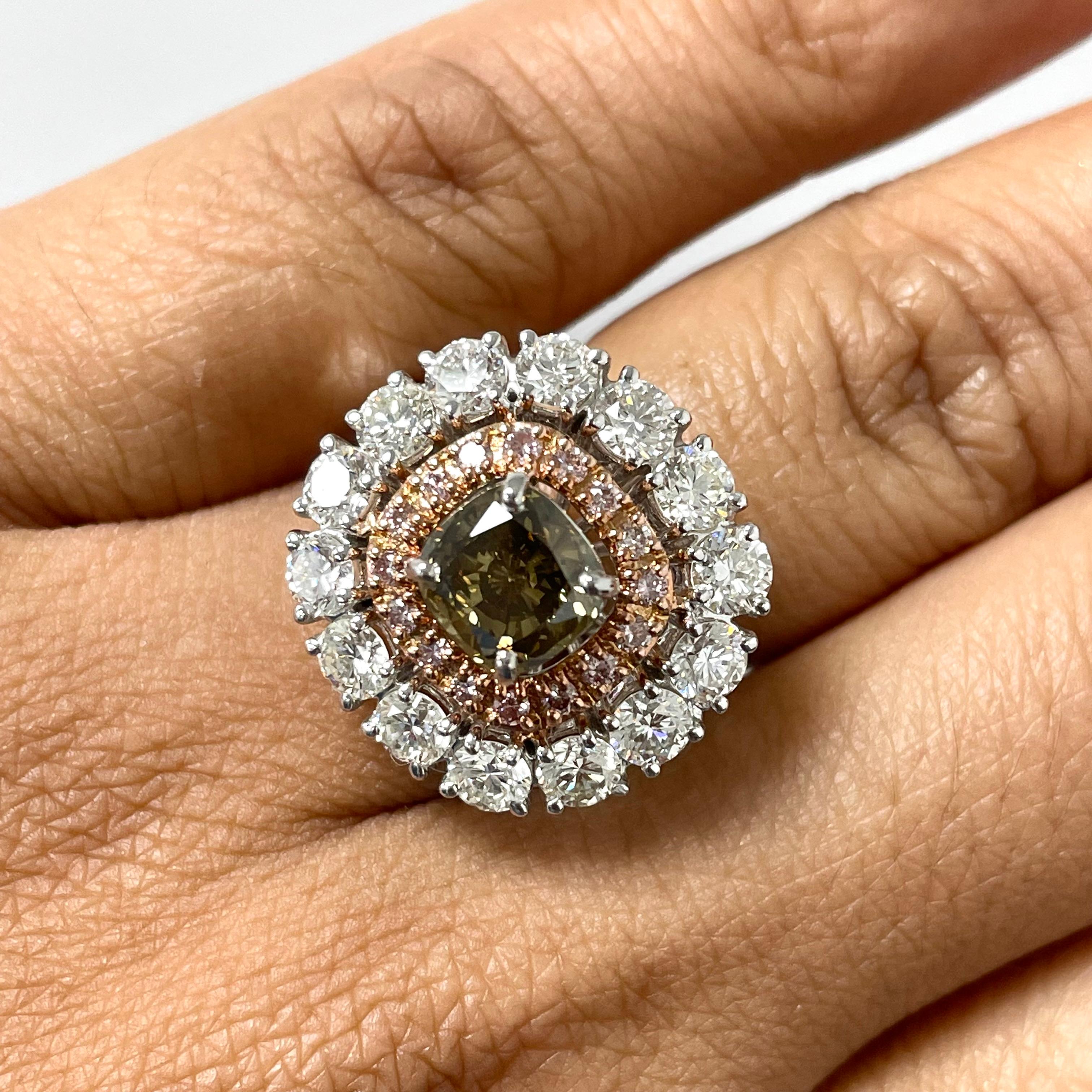This statement ring is all the glitz and glam with is chocolate diamond center and pink diamond halo highlighted by the classic beauty of white diamonds.

Center Diamond Shape: Cushion
Center Diamond Weight: 1.51 ct 
Diamond Color: Brown
Diamond