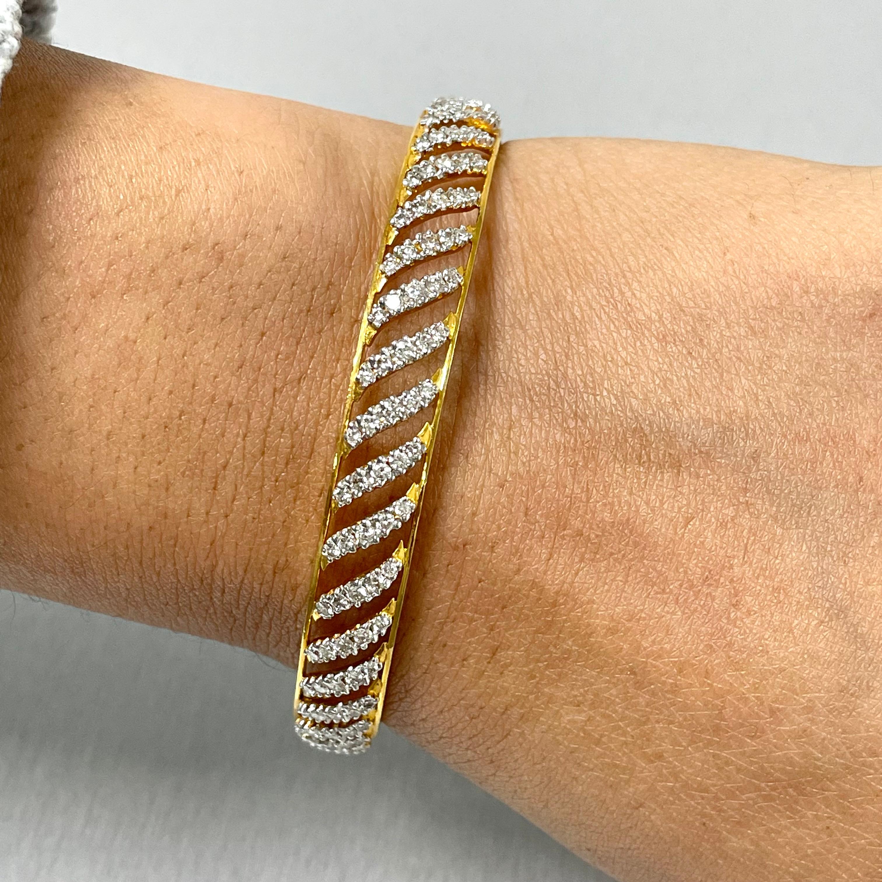 The Curves Bangles Set is inspired and created to reflect Indian tradition and design. With diamonds studded in a yellow gold, these bangles exude an ethereal glow.

Total Diamond Weight: 7.70 ct 
No. of Diamonds: 400
Diamond Color: G - H
Diamond