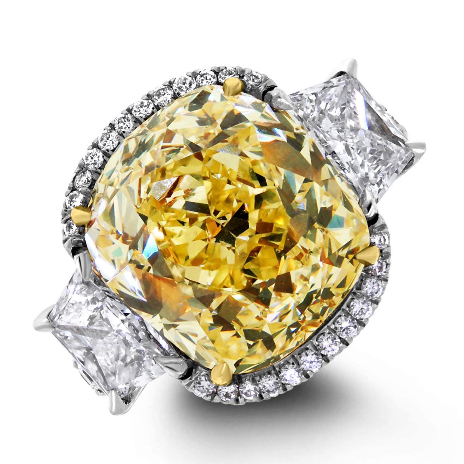 An important 9.77 ct fancy yellow diamond solitaire ring, the Elan features a breathtaking design with a delicate micro-pave halo surrounding the vibrant and fiery Old Cut Cushion center along with Trapezoid side stones to further enhance the