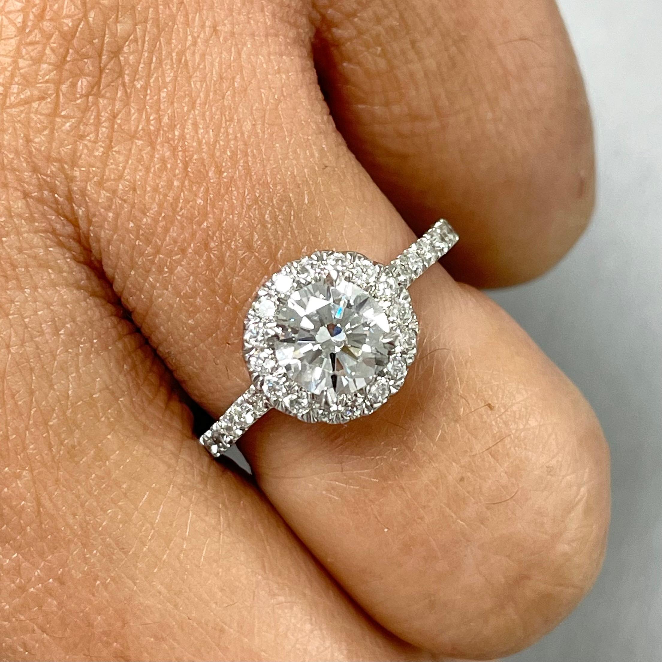 A timeless beauty, this 1 carat HVS2 center round diamond engagement ring with a halo around is elegant and endearing.

Center Diamond Shape: Round Brilliant
Center Diamond Weight: 1.00 ct 
Diamond Color: H
Diamond Clarity: VS2 (Very Slightly