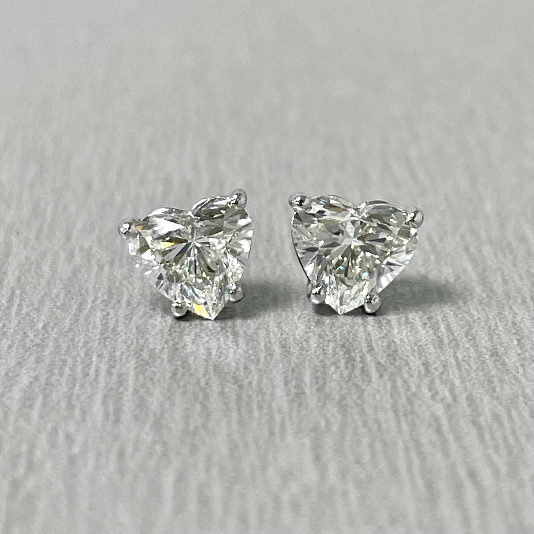 Solitär-Diamantohrstecker sind ein typisches Alltagsschmuckstück. Sie sind ein Klassiker und ein Statement zugleich. 

Dieses besondere Paar herzförmiger Ohrstecker weist eine Tiefe von 58,3 % und 57,1 % auf, wodurch es eher wie ein Paar