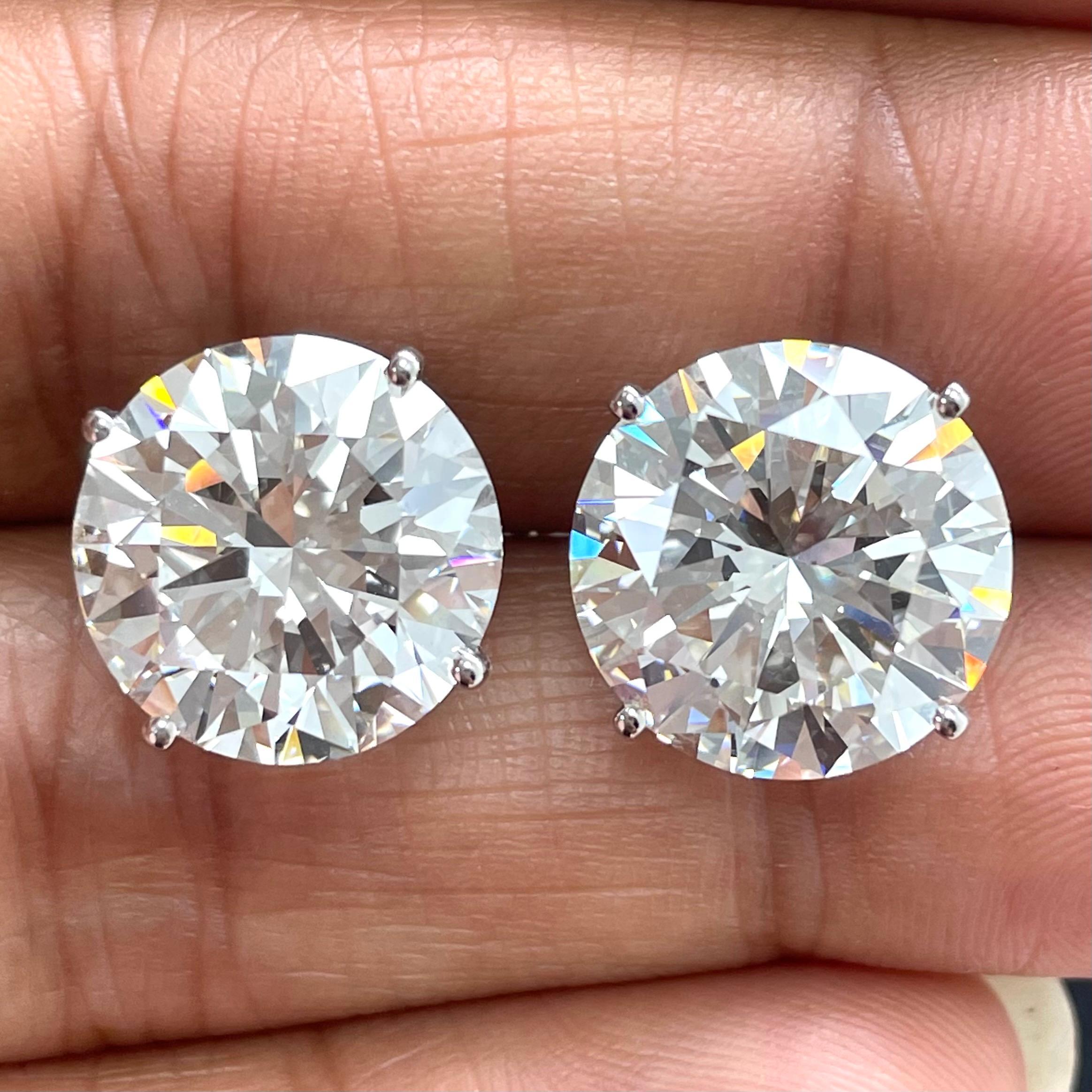 Diamond Solitaire Studs are a signature everyday piece of jewelry. They are a classic and a statement simultaneously. This stunning pair of 7.13 and 6.88 carat IVS2 features perfectly cut diamonds with exceptional fire, luster and