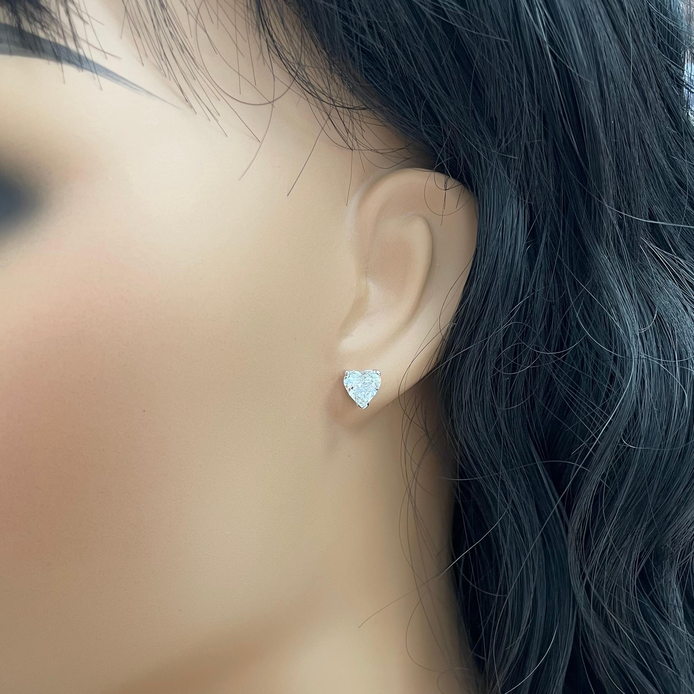 Diamond solitaire studs are a signature everyday piece of jewelry. They are a classic and a statement simultaneously. 
This particular pair of Heart Shape Studs features a depth of 57.5% and 57.6% enabling it to look more like a pair of 1.15 ct each