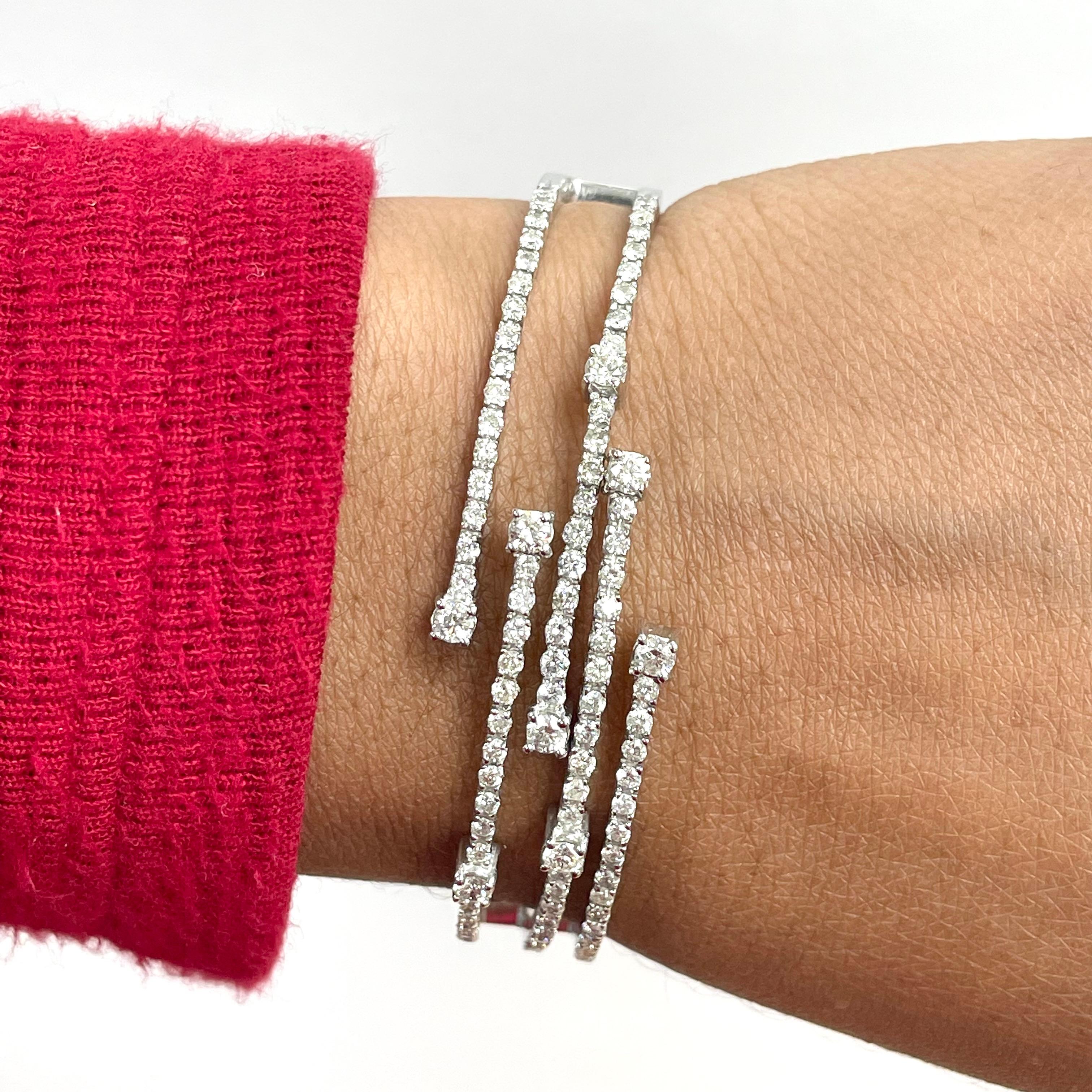The Krisha bangle is a perfect modern jewel to adorn the wrist. With strands of diamonds closing to embrace the wrist and larger diamonds popping in places, its a timeless statement jewel.

Diamonds Shapes: Round 
Side Diamonds Weight: 2.45 ct 
Side