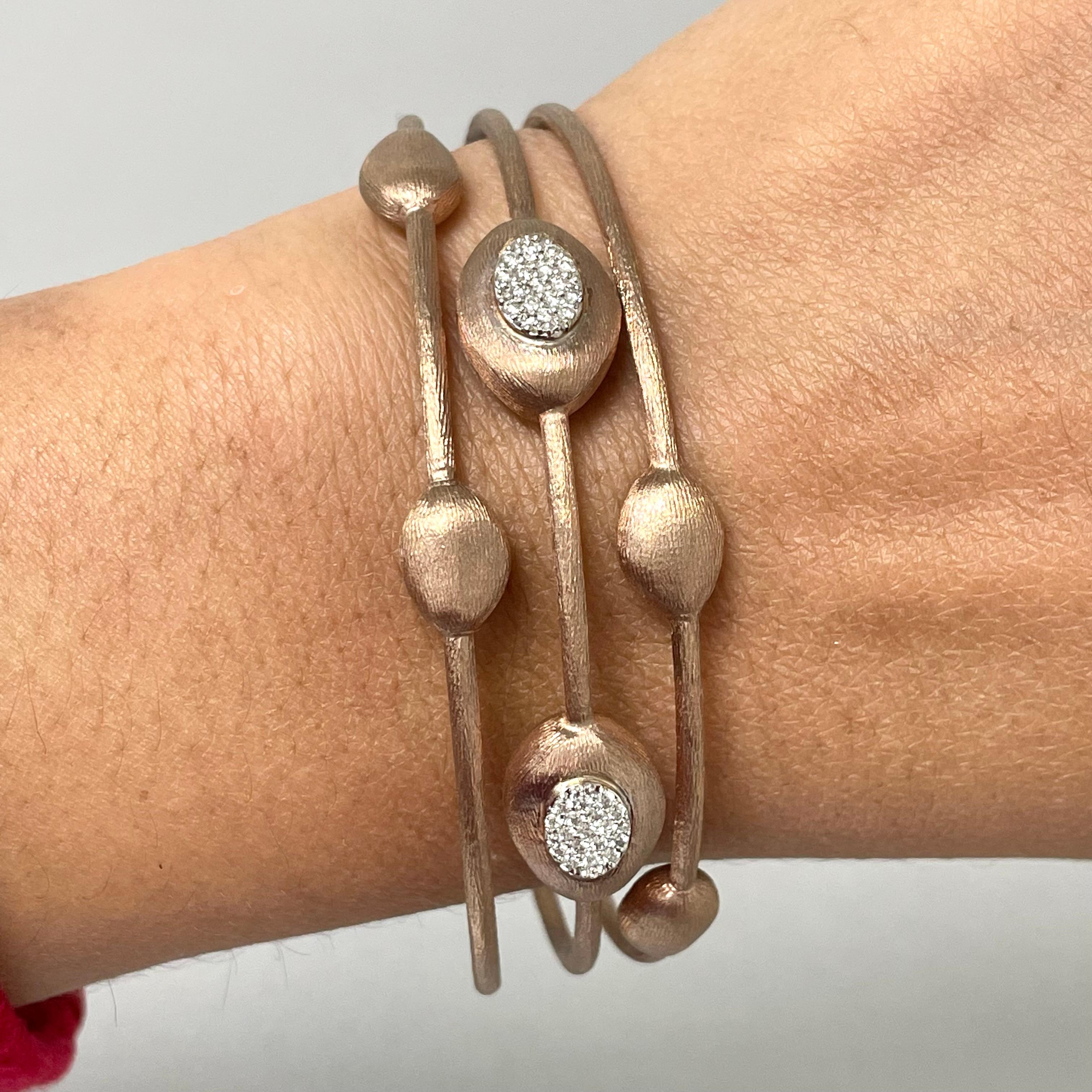 The Pulse Bangles have a unique metal styling giving them the feel of something antique or classical yet modern. They combine bold and delicate elements into a elegant piece of jewelry. 

Total Diamond Weight: 0.25 ct 
Diamond Color: G - H 
Diamond