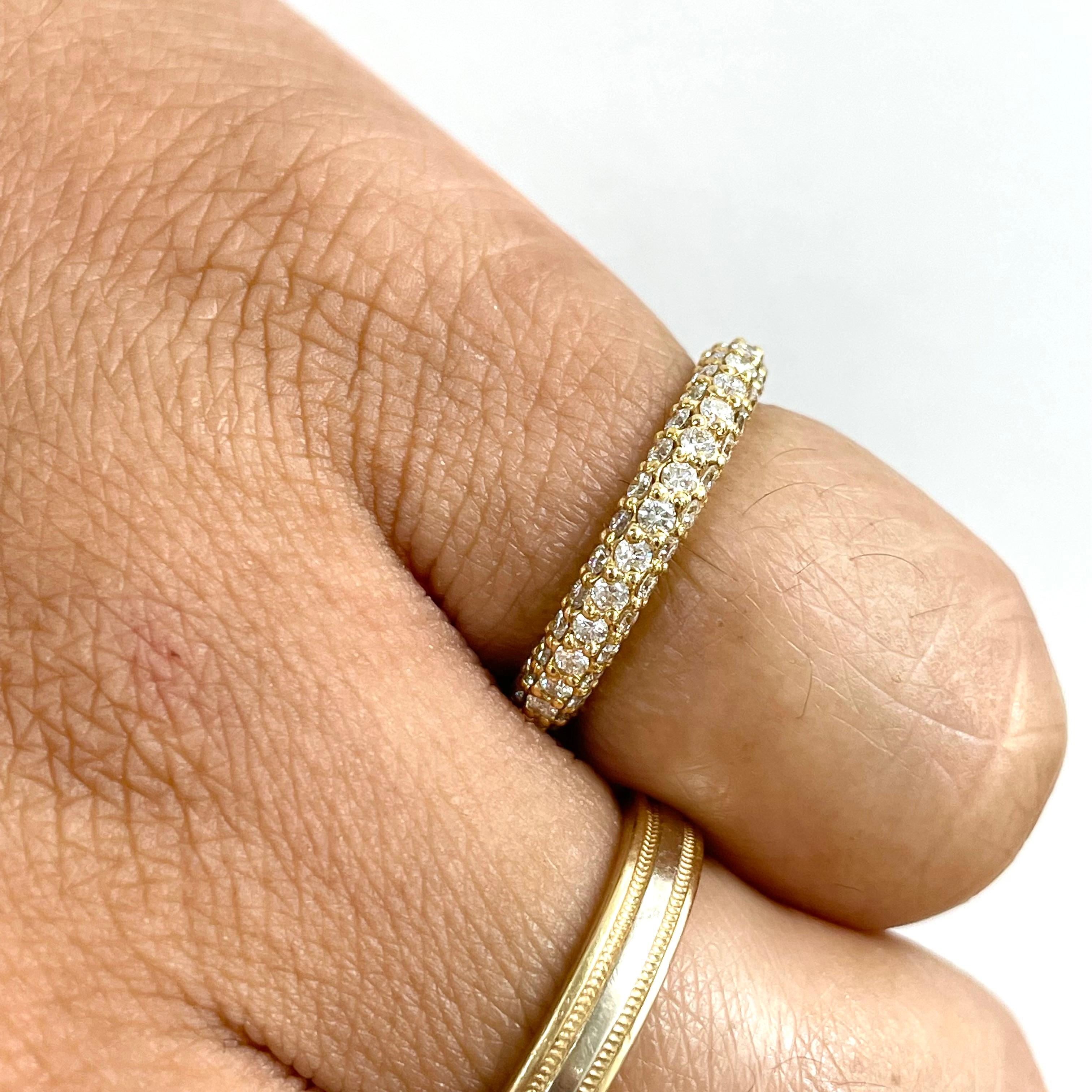 This gorgeous and versatile band makes a perfect pinky ring, wedding band or addition to a ring stack. The three row yellow gold setting is full of life and luster. It is just shy of an Eternity Ring leaving a short metal shank (approximately 5 mm