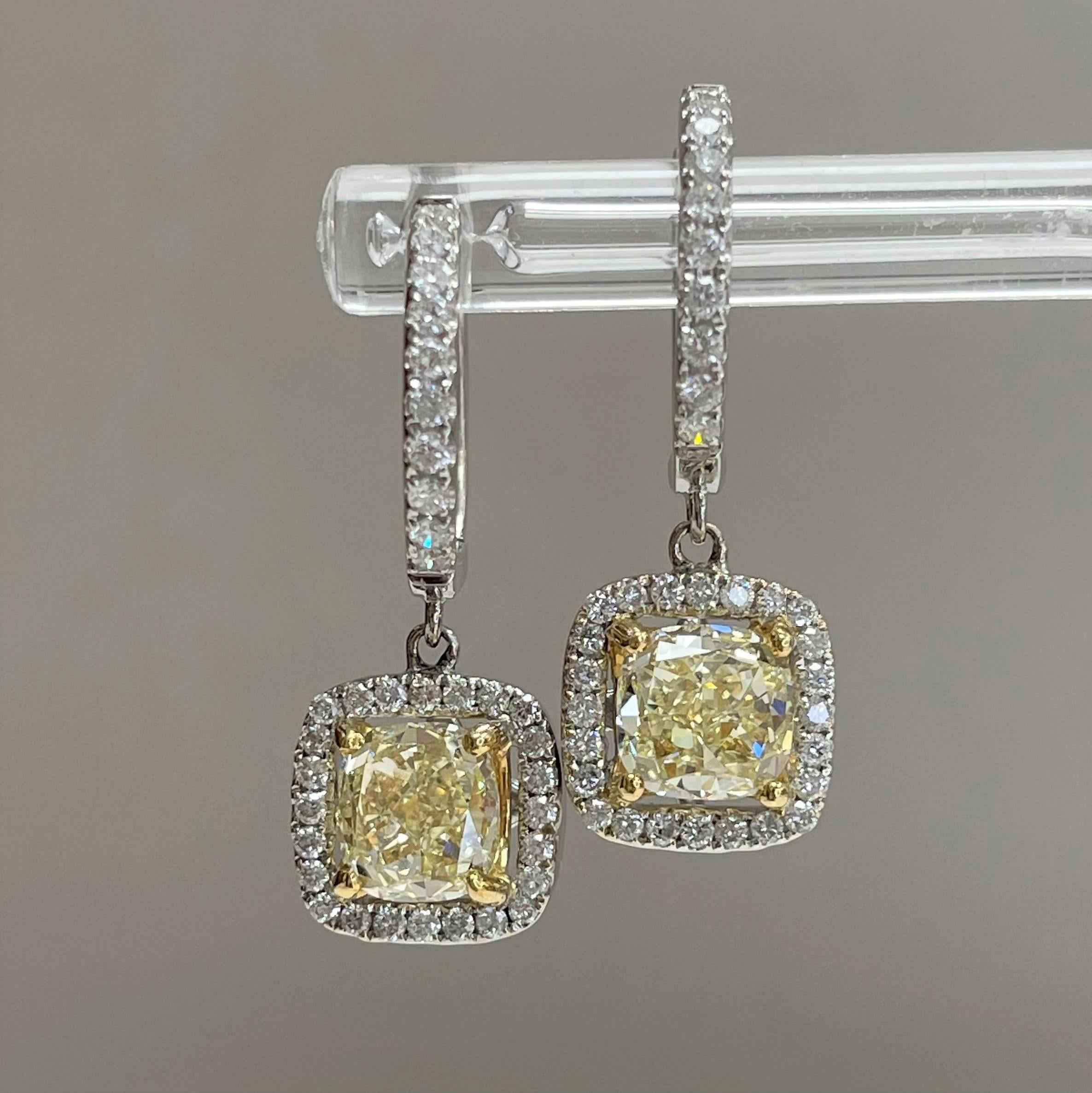 These contemporary Yellow Diamond earrings make a bold and daring statement regardless of time and place. 

Center Diamond Shape: Cushion
Center Diamond Weight: 1.51 ct + 1.51 ct  
Diamond Color: Q-R & S-T
Diamond Clarity: IF & VVS2 (Internally