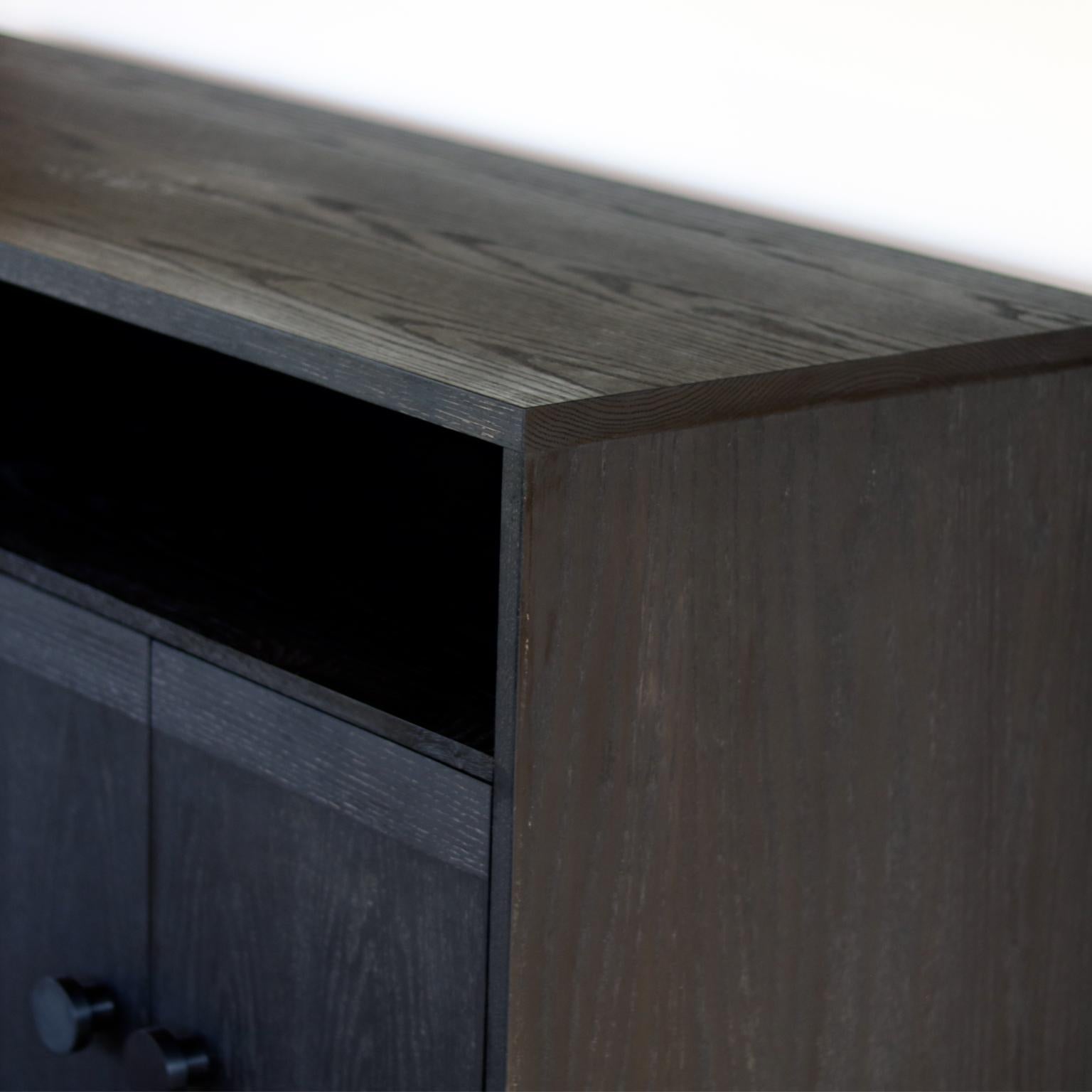 Featuring solid oak construction, aluminum powder coated black knobs, and steel legs.

The Beauvoir cabinet is completely customizable.  