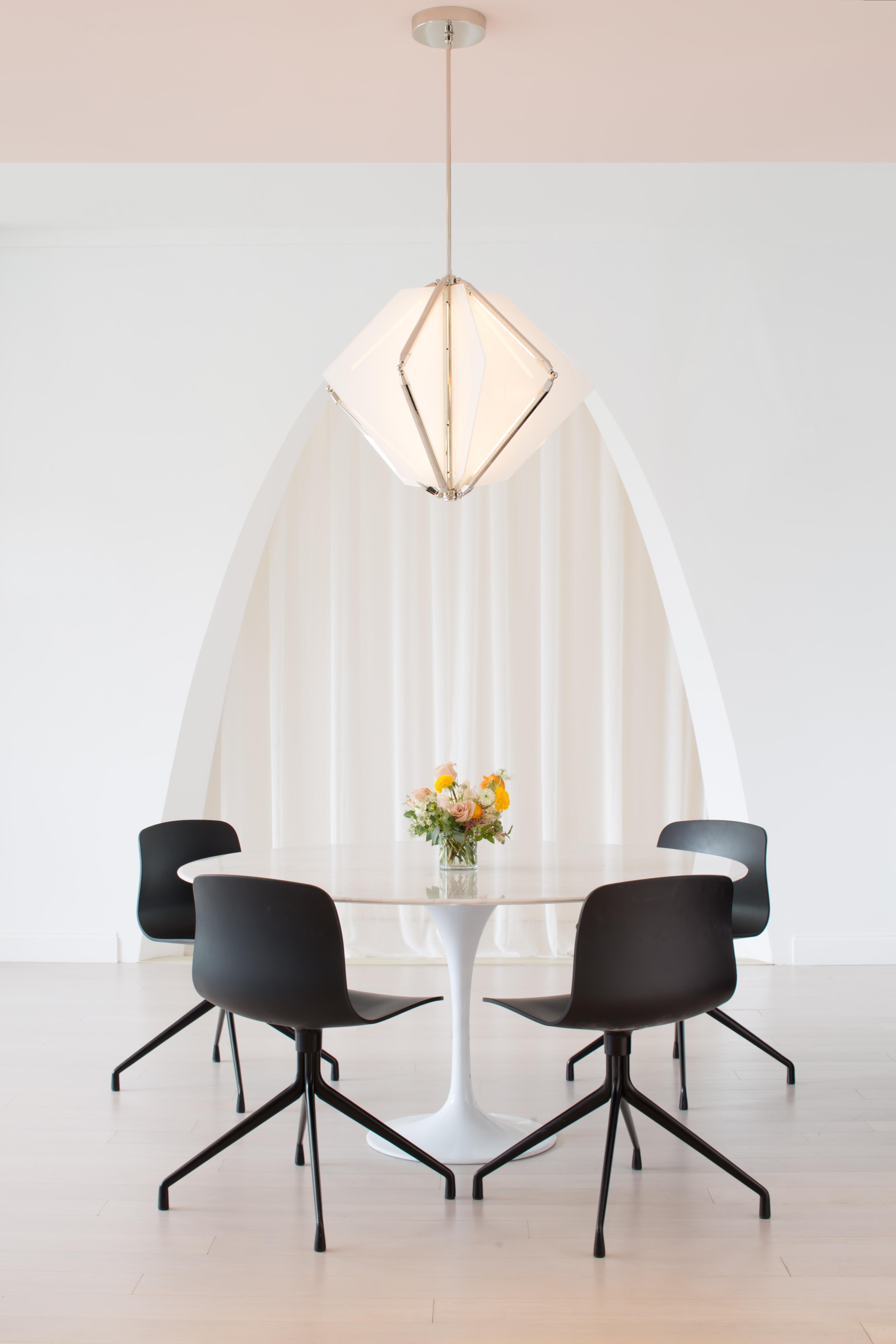 Echo uses fins of mirror radiating from a central axis to reflect beams of light. LED tubes are turned inward to bounce off the glass; the light becomes both softened and multiplied. Also available with fins of glass which diffuse the light and