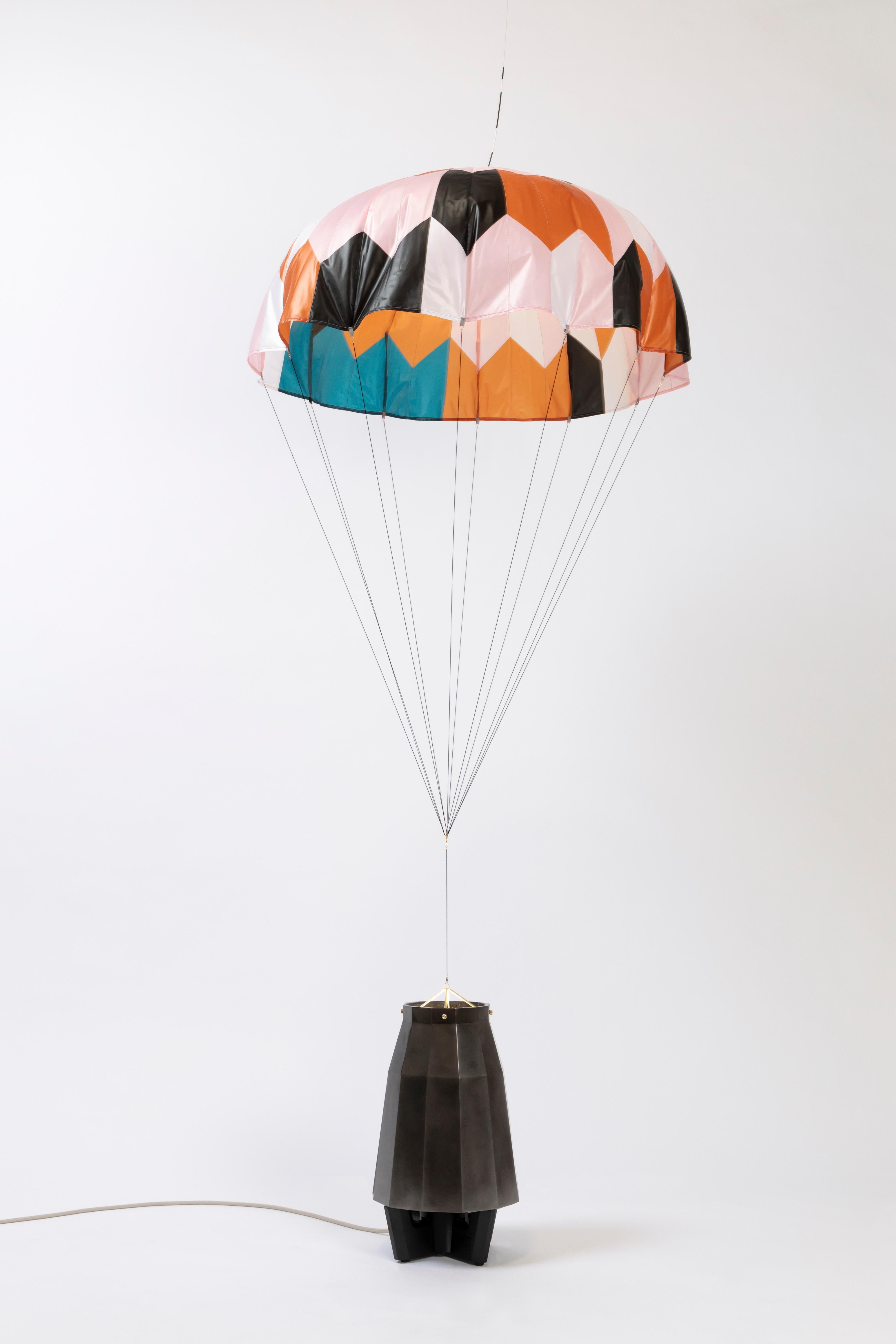 Unique and dynamic parachute lamp with a lacquered black aluminum base. A clever and engaging piece that enhances any space.

Additional Information:
From acclaimed lighting designer Bec Brittain, a new series of dynamic, whimsical lighting forms