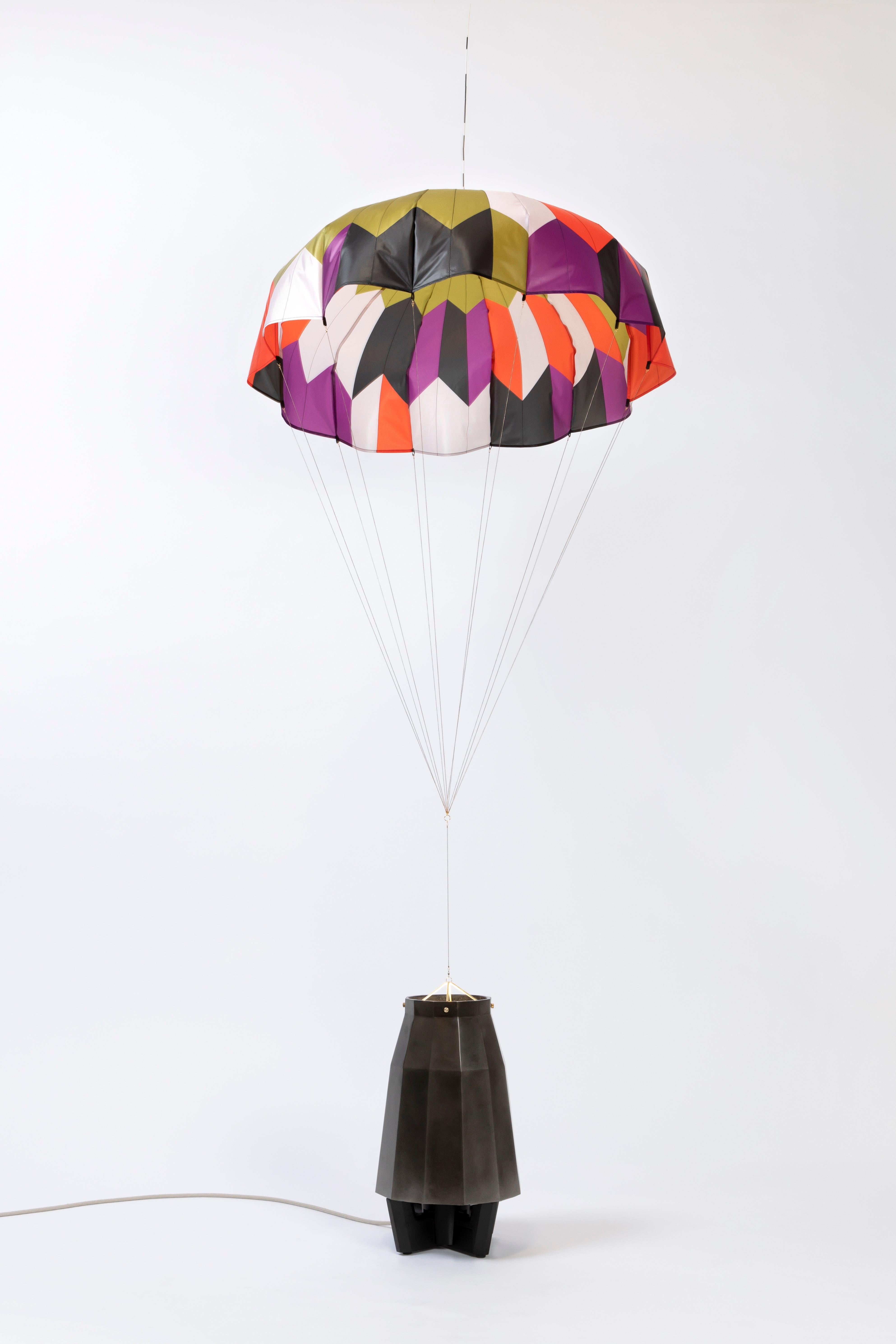 Unique and dynamic parachute lamp with a lacquered black aluminum base. A clever and engaging piece that enhances any space.

Additional Information:
From acclaimed lighting designer Bec Brittain, a new series of dynamic, whimsical lighting forms