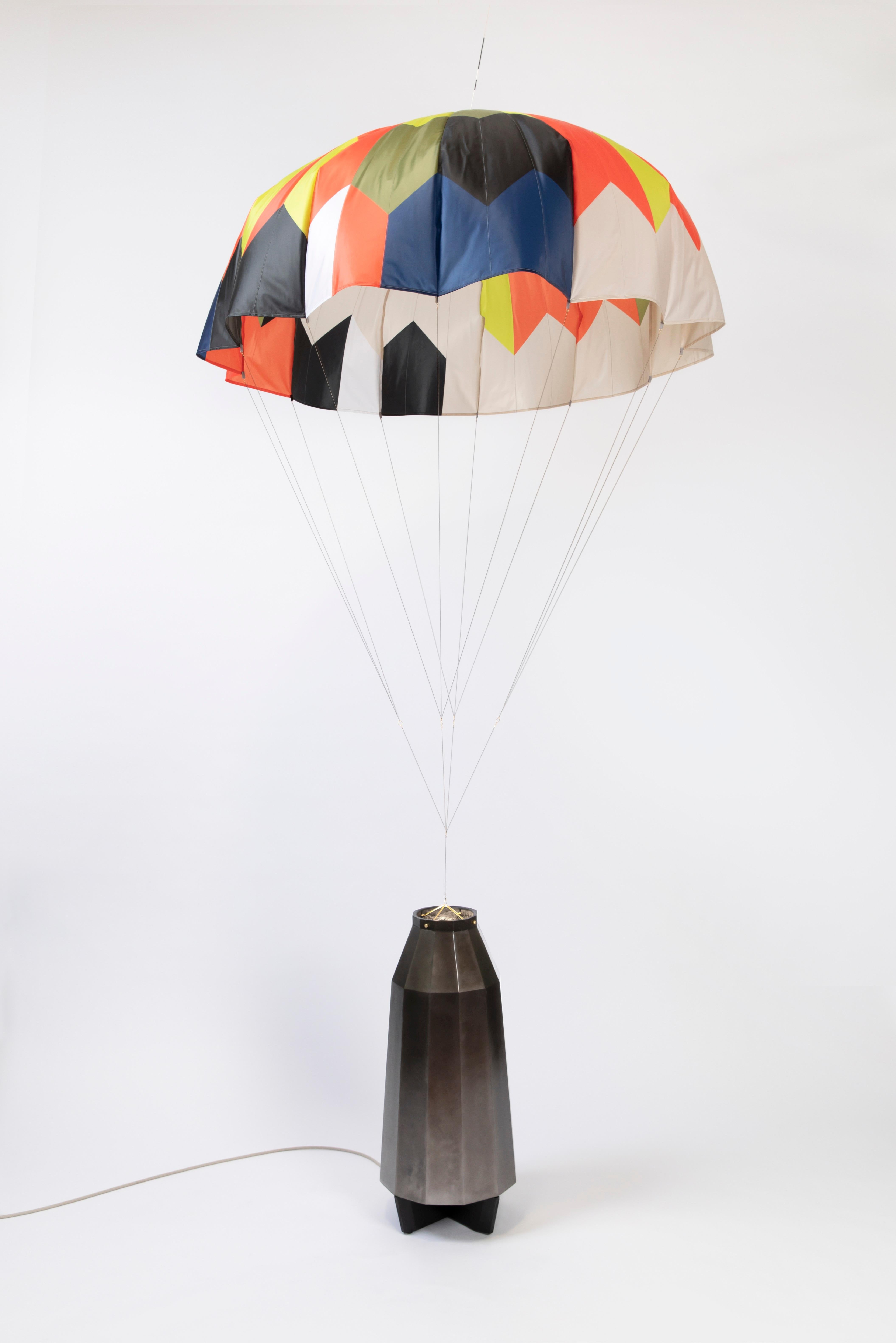 Unique and dynamic parachute lamp with a lacquered black aluminum base. A playful and engaging piece that enhances any space.

Additional Information:
From acclaimed lighting designer Bec Brittain, a new series of dynamic, whimsical lighting forms