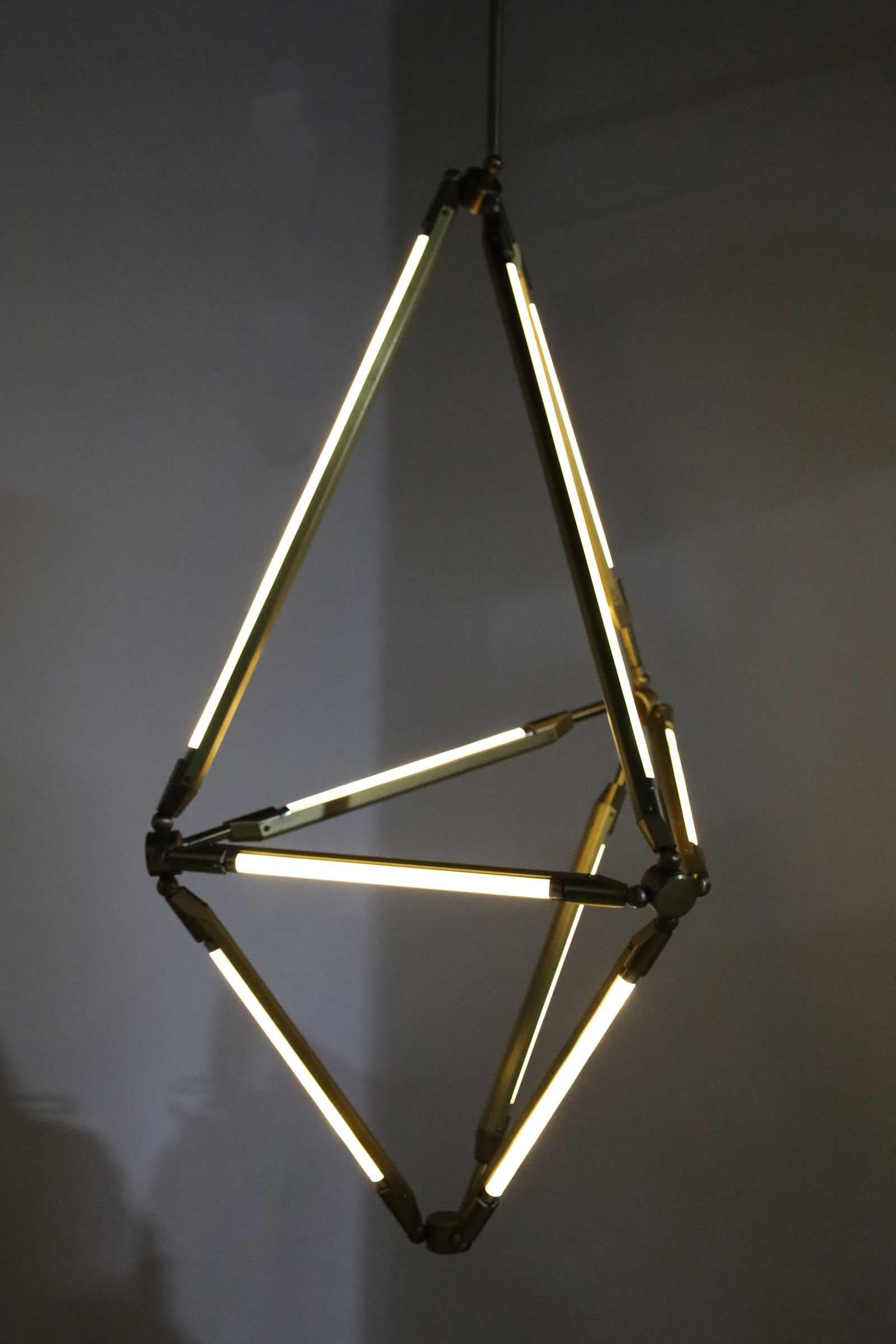 The critically acclaimed Shy Chandelier was launched by Bec Brittain in 2011. 

The SHY light uses the spare beauty of thin LED tubes to define the edges of its shape; in this way the function of the piece is created by its form and vice versa. The