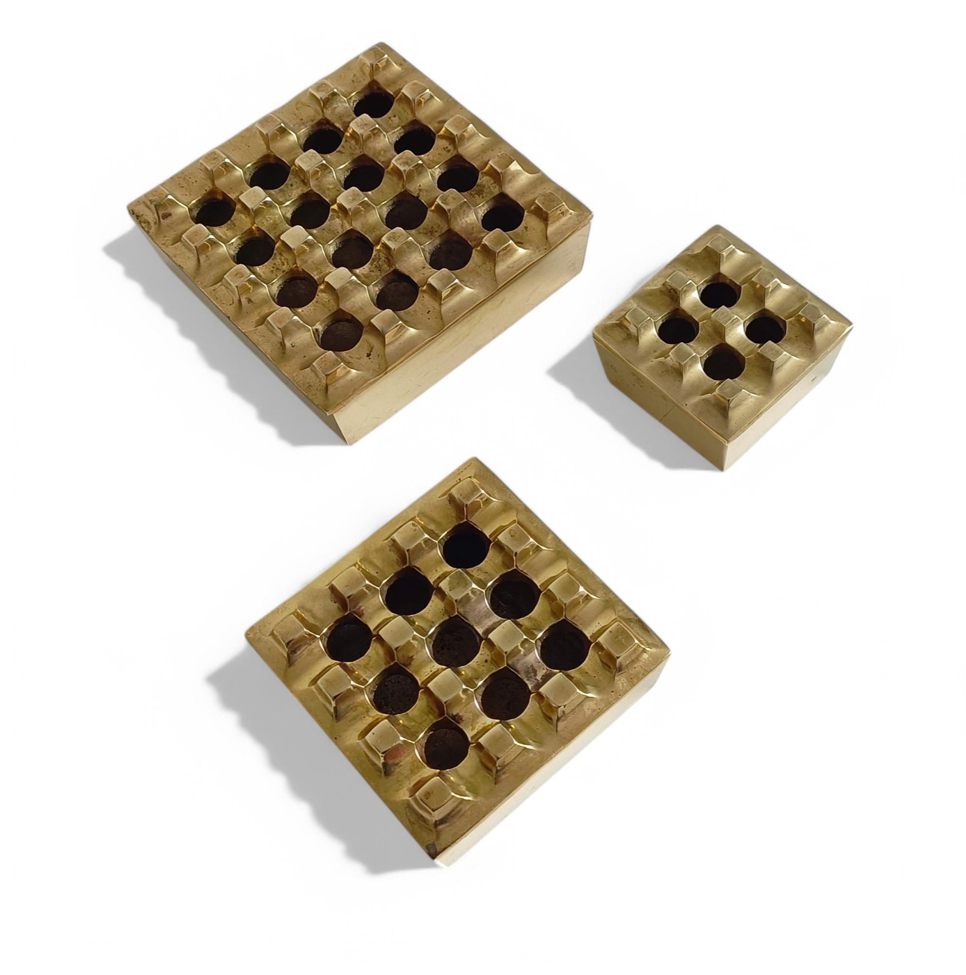 Beck & Jung Ultima 15 set of three ashtrays, a striking example of Post-Modern design by Swedish duo Holger Bäckström and Bo Ljungberg. 

Made from bronze with clean, geometric lines, they reflect the bold, unconventional aesthetic of the era.