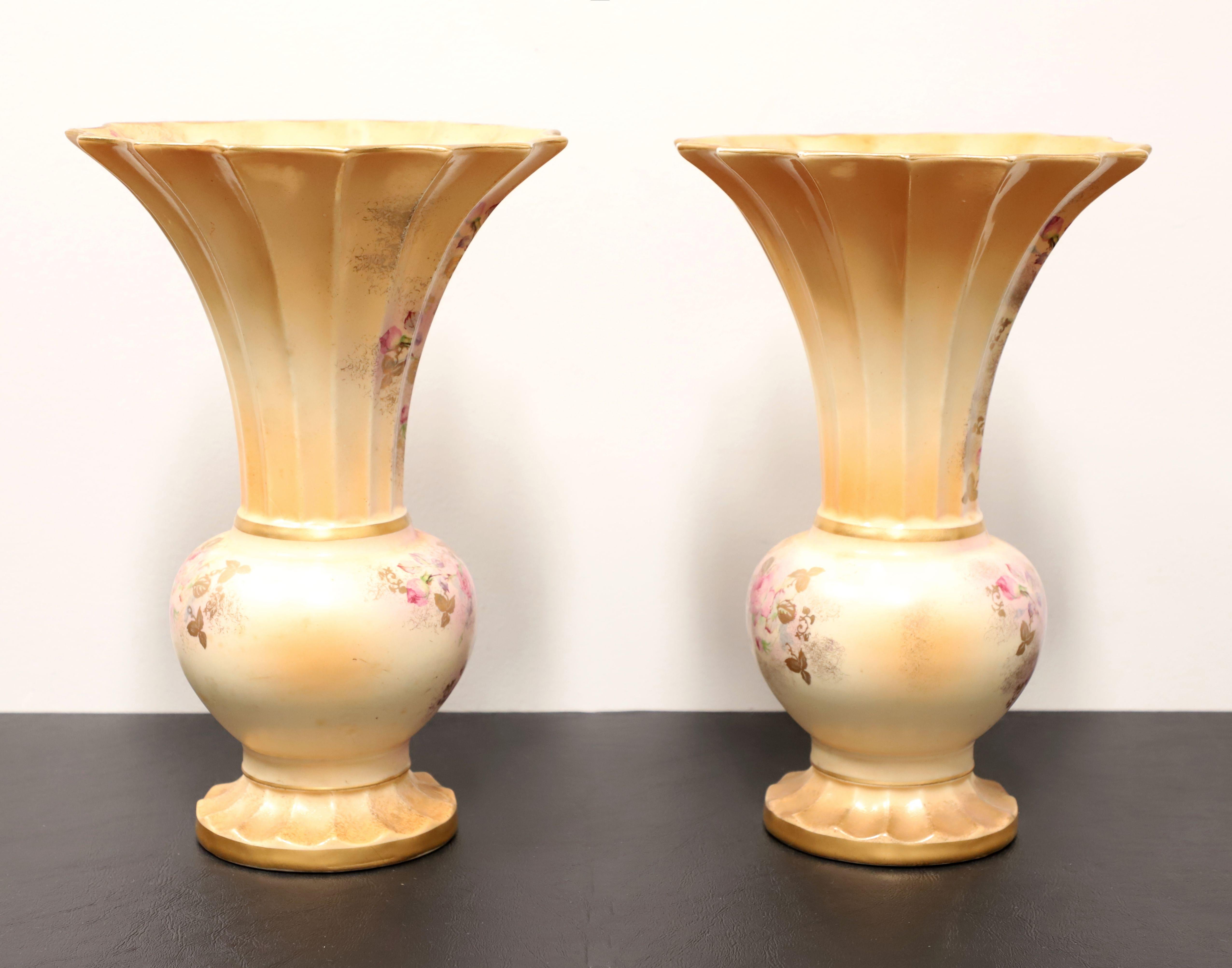 A pair of porcelain table vases by Beckwith China. Hand painted porcelain with a clustered roses design, urn shape, fluted opening, and footed. Made in Japan, in the mid 20th Century.

Measures:   8w 8d 12h Each, Weighs Approximately: 2 lb