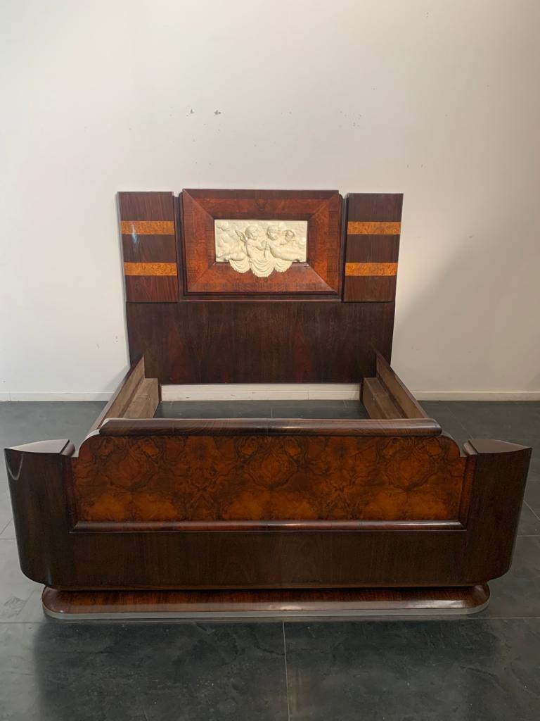 Rosewood and walnut bed & bedside tables with cherub carving by Ducrot, 1929, set of 3.
Set bed and bedside tables of the main suite of the liner Giulio Cesare launched in 1920 in Palermo with the first trip from Genoa in 1922. Completely fitted