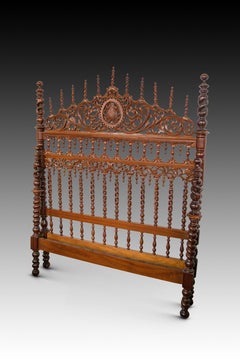 Bed frame. Carved and turned wood. 20th century, following ancient models.
