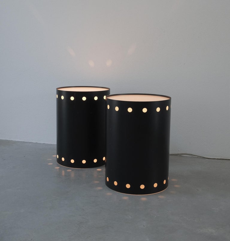 Black bed side tables with lights, Germany circa 1965- sold as a pair

Very rare tubular blackened steel side tables that work with dimmable lamps. Stunning 1960 design made from steel sheet and Lucite. Both work with a large e26/27 bulb up to 75W
