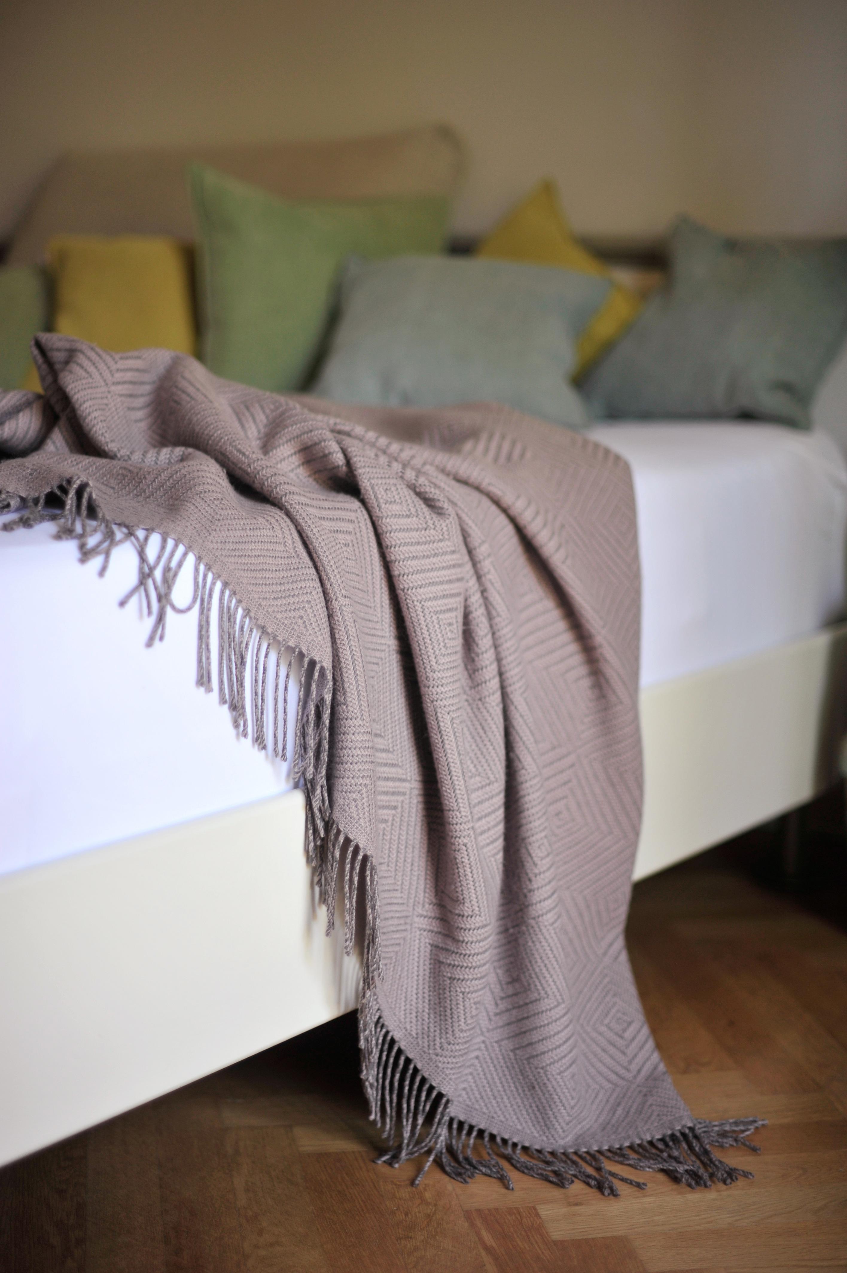 Designed in Berlin by Catharina Mende, woven of 100% extra fine merino in Scotland: This exquisite bed throw in color mauve, woven in Scotland from finest extra fine merino, is a piece of beauty and elegance for every bedroom - day and night, winter