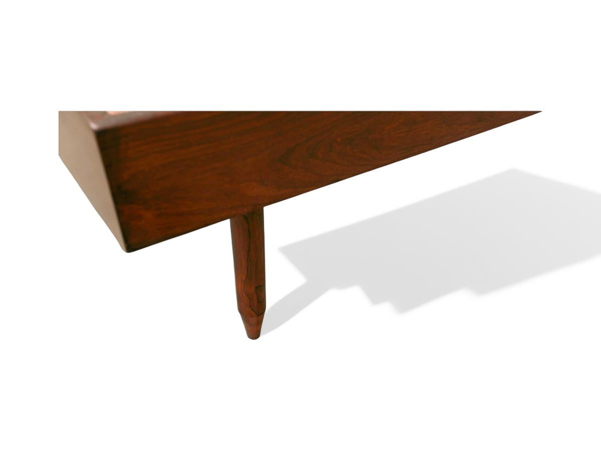 This one of a kind bed with headrest was designed by Carlo Hauner in the fifties and is truly a masterpiece. The set is entirely made in Brazilian Rosewood, known as Jacaranda. The king bed consists of two structures with sculpted cone shaped legs.