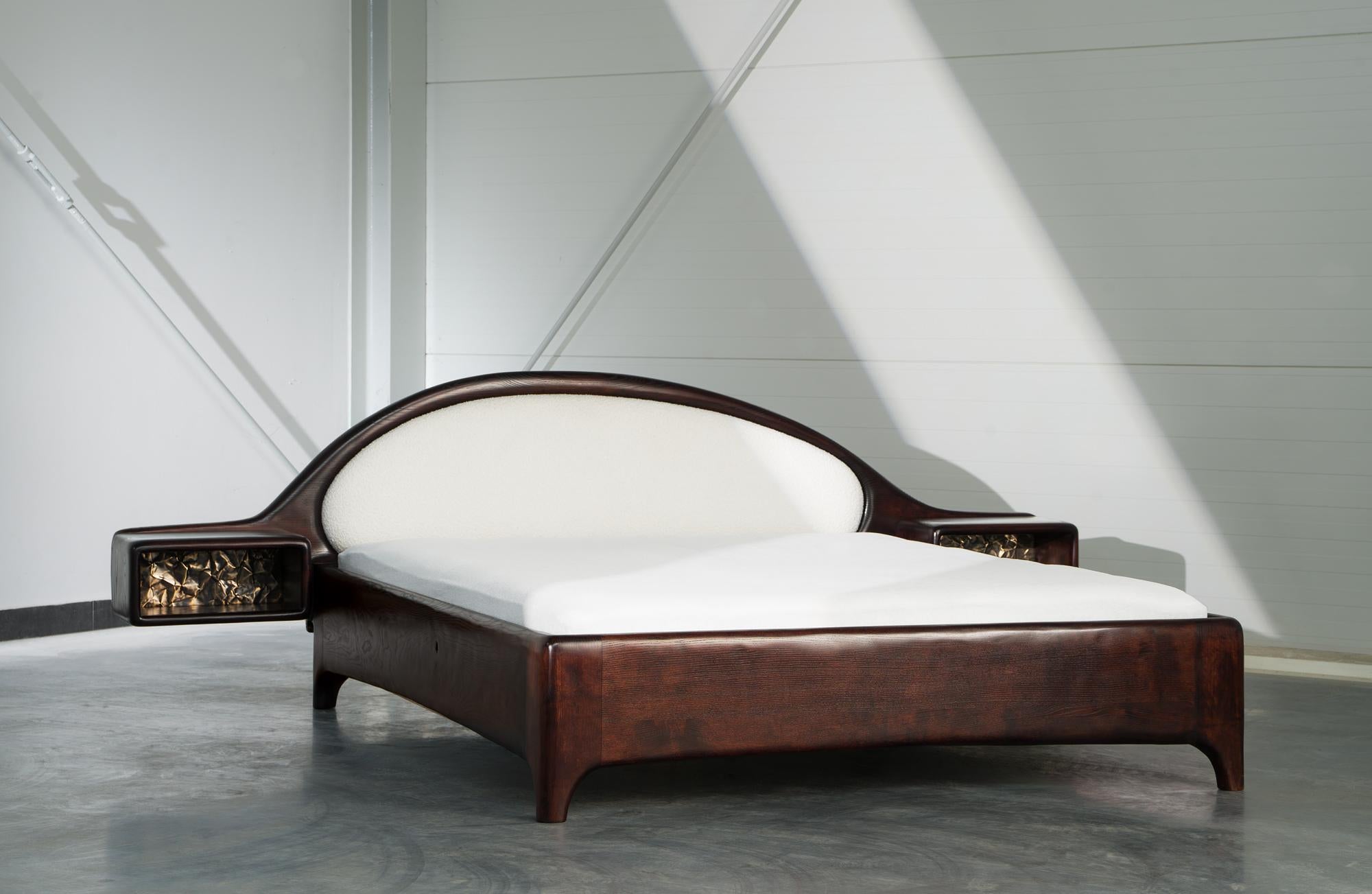 Bed with Nighstand by Tomasz Omachel 
Dimensions: D 215 x W 275 x H 90 cm. 
Materials: Ash, Fabric and Brass.


Tomasz Omachel (1984) is a self-taught maker. His story began in furniture renovation, where he learned the secrets of the craft by