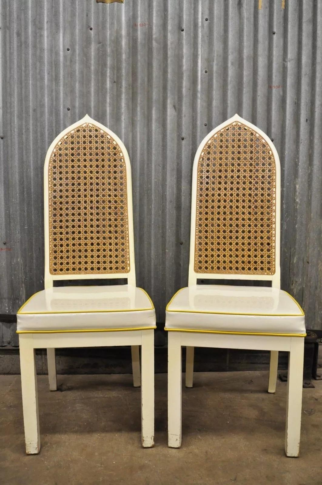 Pair of Bedell Vintage Hollywood Regency Cane Back Pagoda Dining Side Chairs (A). Item features pointed cane backs, white vinyl seat, white lacquer finish, solid wood construction, clean modernist lines. Circa Mid 20th Century. 48