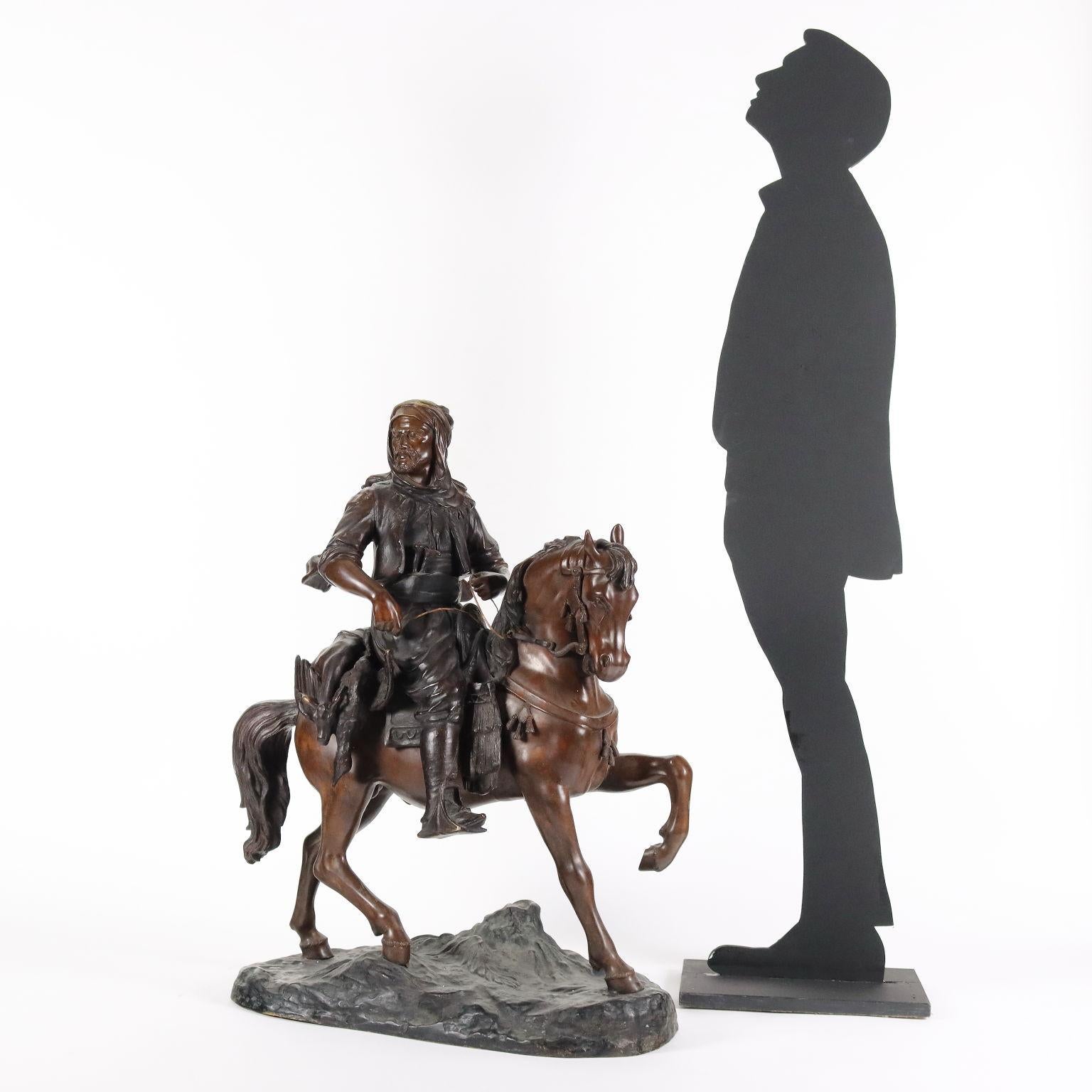 Large bronze sculpture depicting a Bedouin on horseback with game. Based on the manufacturer's brand engraved.