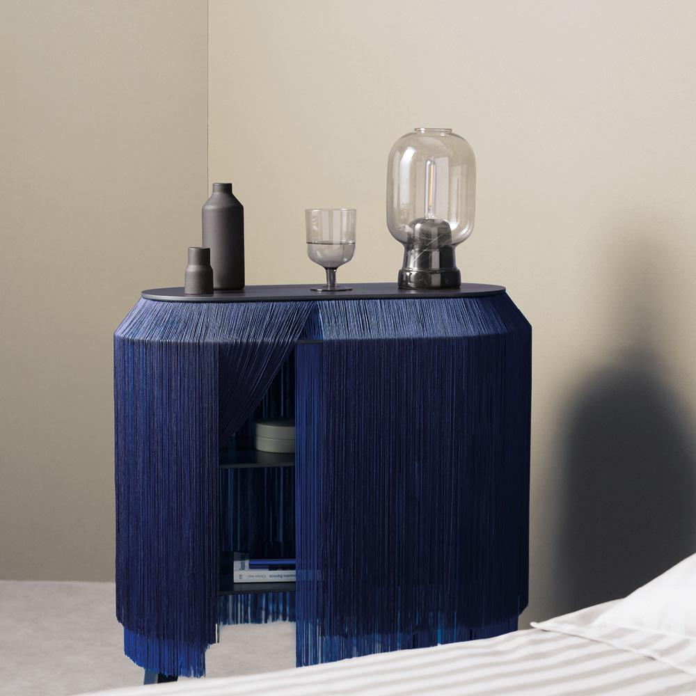 Baby Alpaga is distinguished by its long viscose fringes, offering a refined appearance reminiscent of a miniature boudoir on legs. This original bedside cabinet allows for discreet storage of secret objects behind these elegant fringes.

This