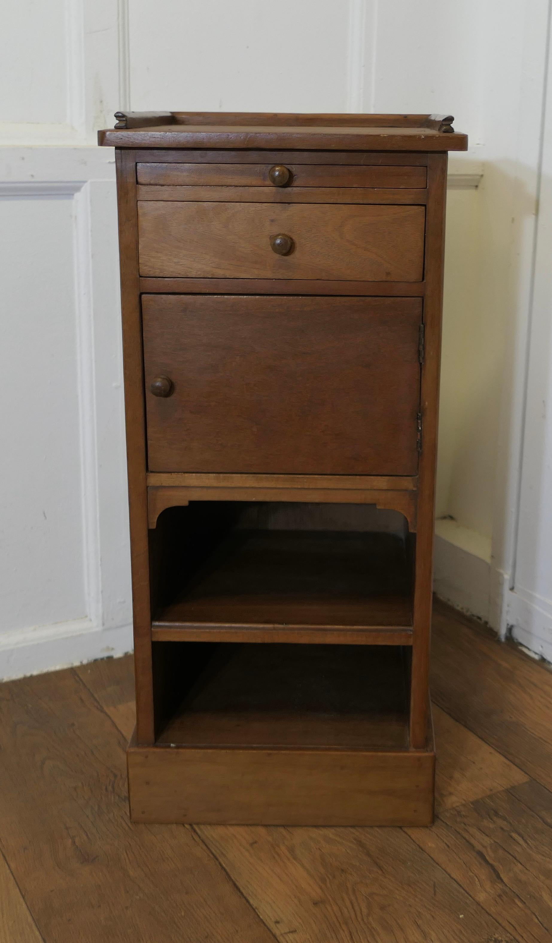  Bedside Cupboard with Brushing Slide

This is an unusual piece, it has a small gallery around the top with a brushing side and a drawer then a small cupboard below these, and even a shoe hole below
The cabinet is in sound condition, it is 31” tall,