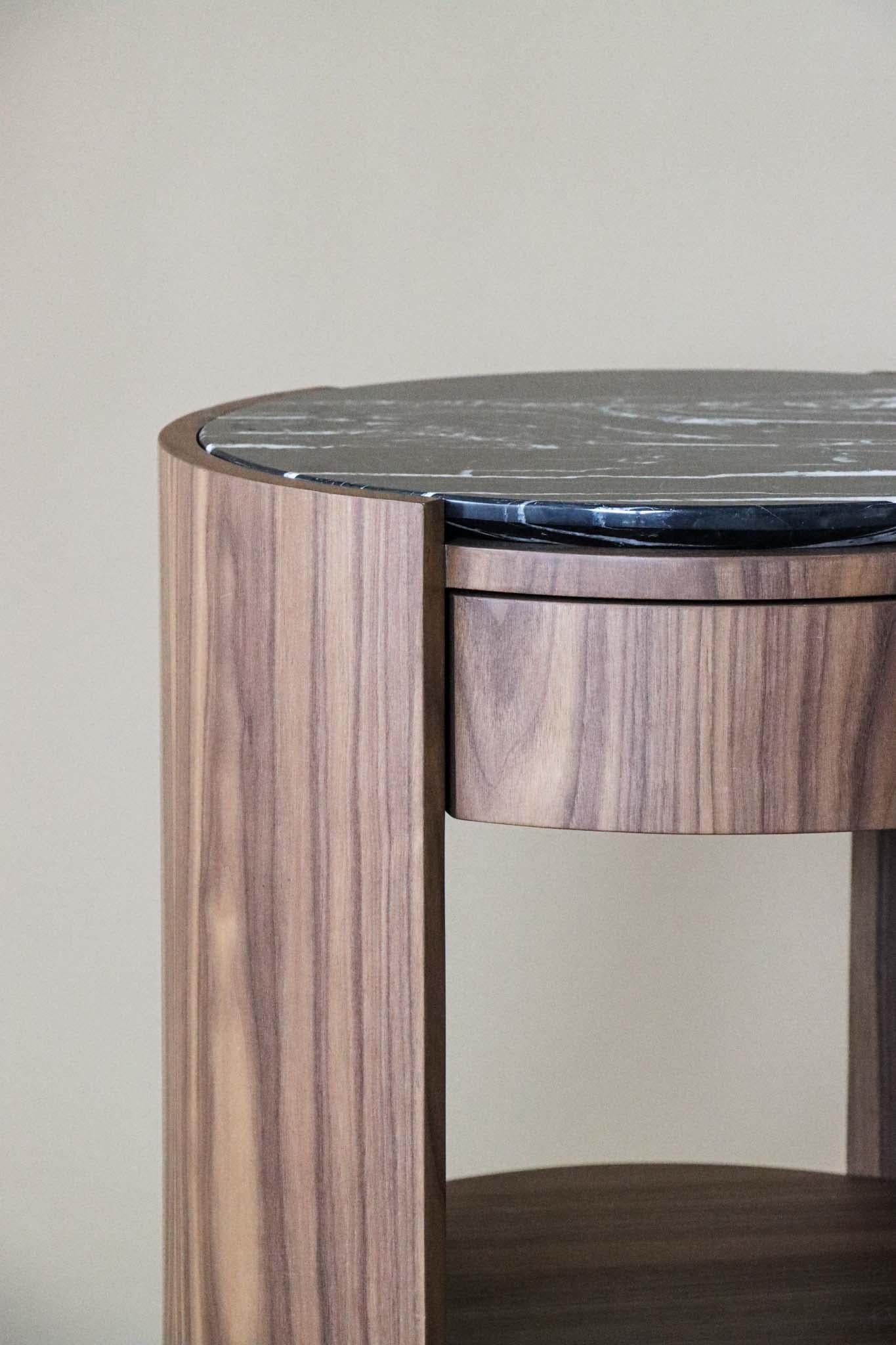 The perfect complement to a refined resting space.
The Dama Nightstand pairs the warmth of walnut with the depth of black marble, creating a striking contrast between natural texture and sculptural elegance. Its serene presence and impeccable