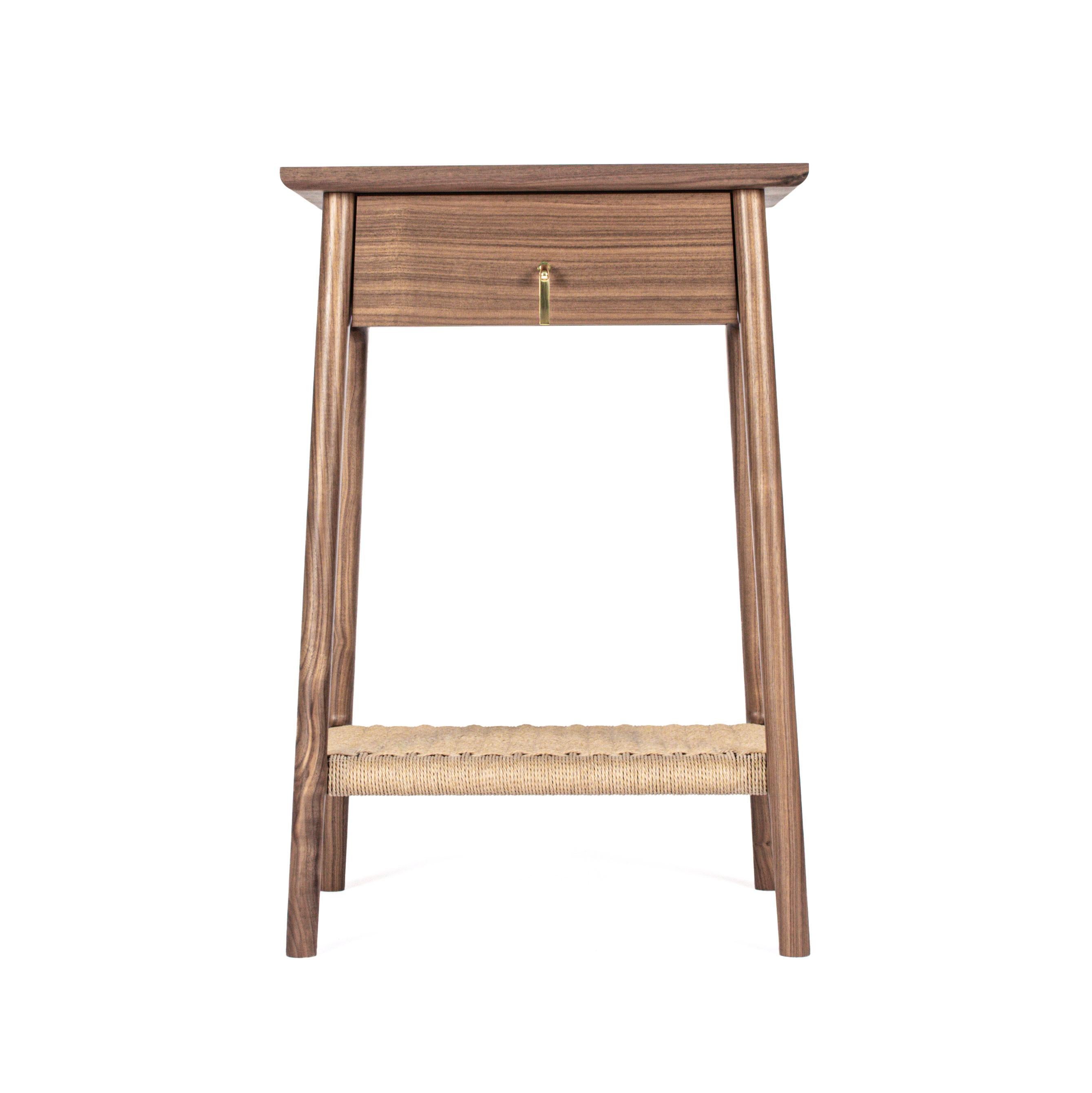 Hardwood bedside table with a drawer and a woven Danish Cord undercarriage. The custom brass pull is inspired by nature, the California Quail topknot. Can be made with or without the woven undercarriage. Feature changes as well as dimensional