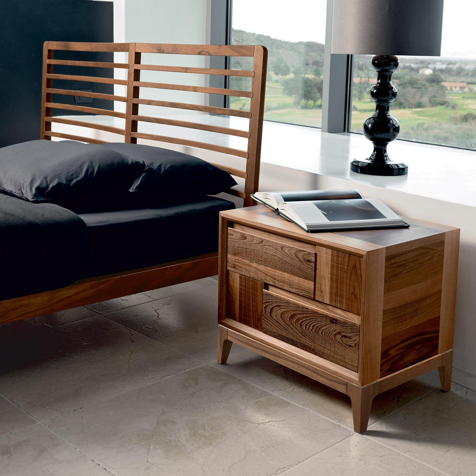 Its linear simplicity fits perfectly with contemporary, timeless interior design. 
The bedside table it's crafted in Italy by expert hands, in premium walnut veneer blackboard, and two drawers in sawn effect solid walnut, oil finish. Since it’s a