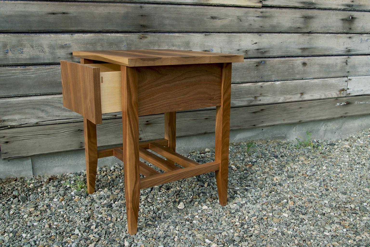 Modern, hardwood rift end table, nightstand storage bedside table. The bedside table features timeless lines, subtle tapers, a soft close drawer and a wooden under carriage for storage.

This listing is for a Rift bedside table in walnut.
