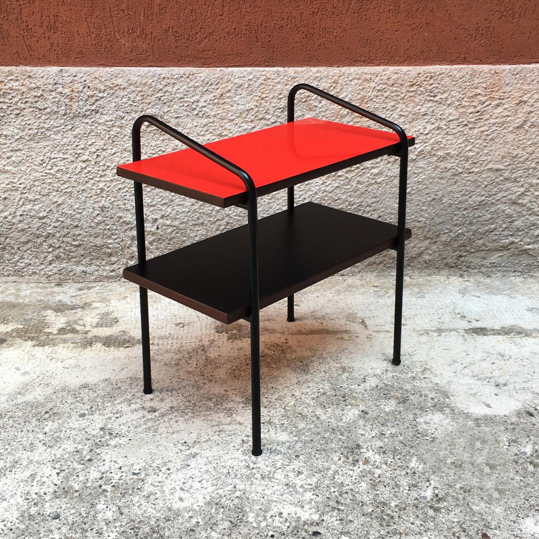 Bedside table with double colored shelves, 1960s
Bedside table with double shelves, dating to the 1960s, coming from an old hotel in middle Italy, together with many small desks, in the same style. Black metal rod, repainted with opaque finishing,