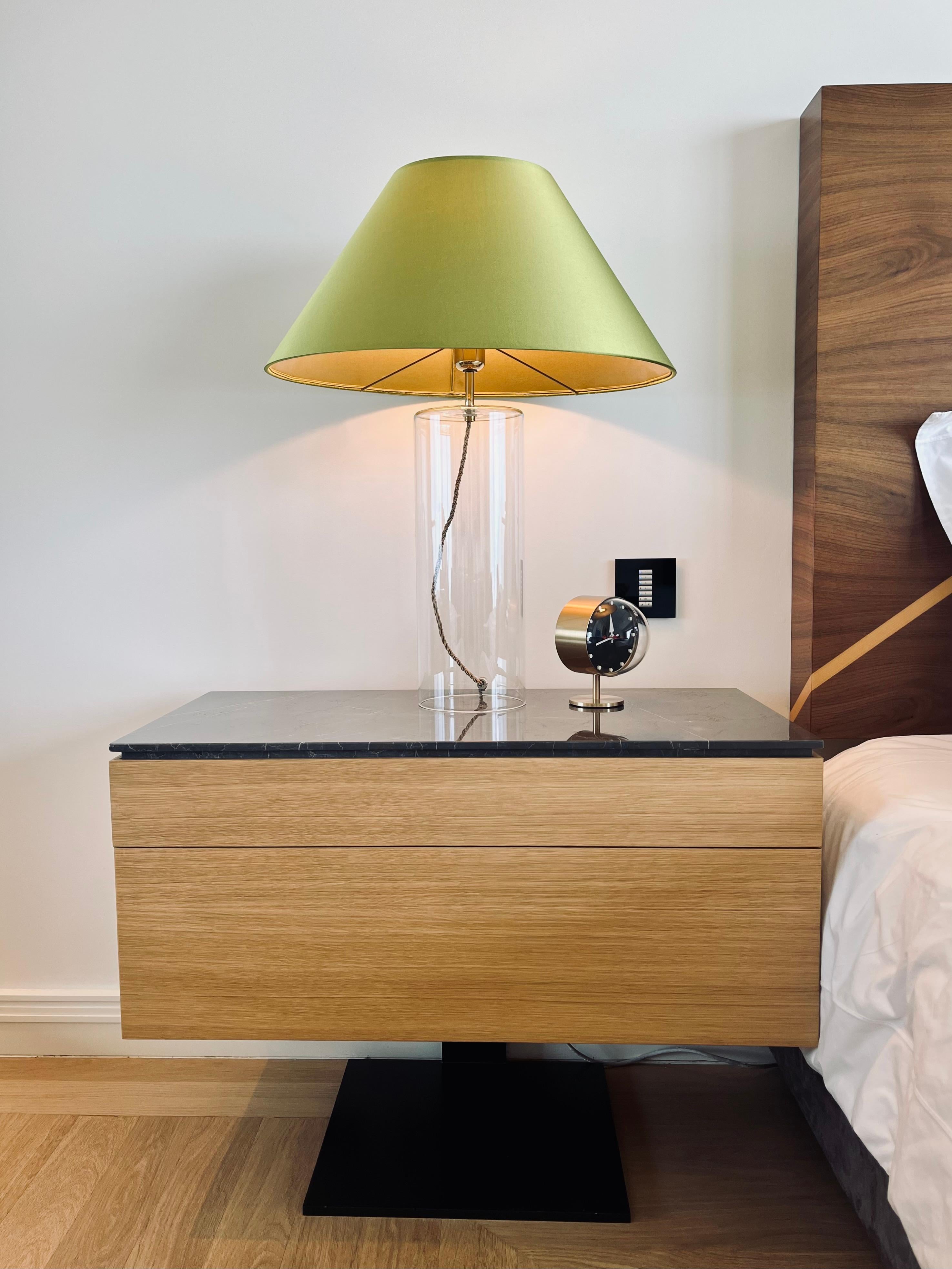 Bedside table with two push to open drawers.

The table is entirely wrapped in maple veneer with top in Marquina marble. 
Single leg and base is metal spray painted black.

As with all our furniture, this bedside table is made to order and is