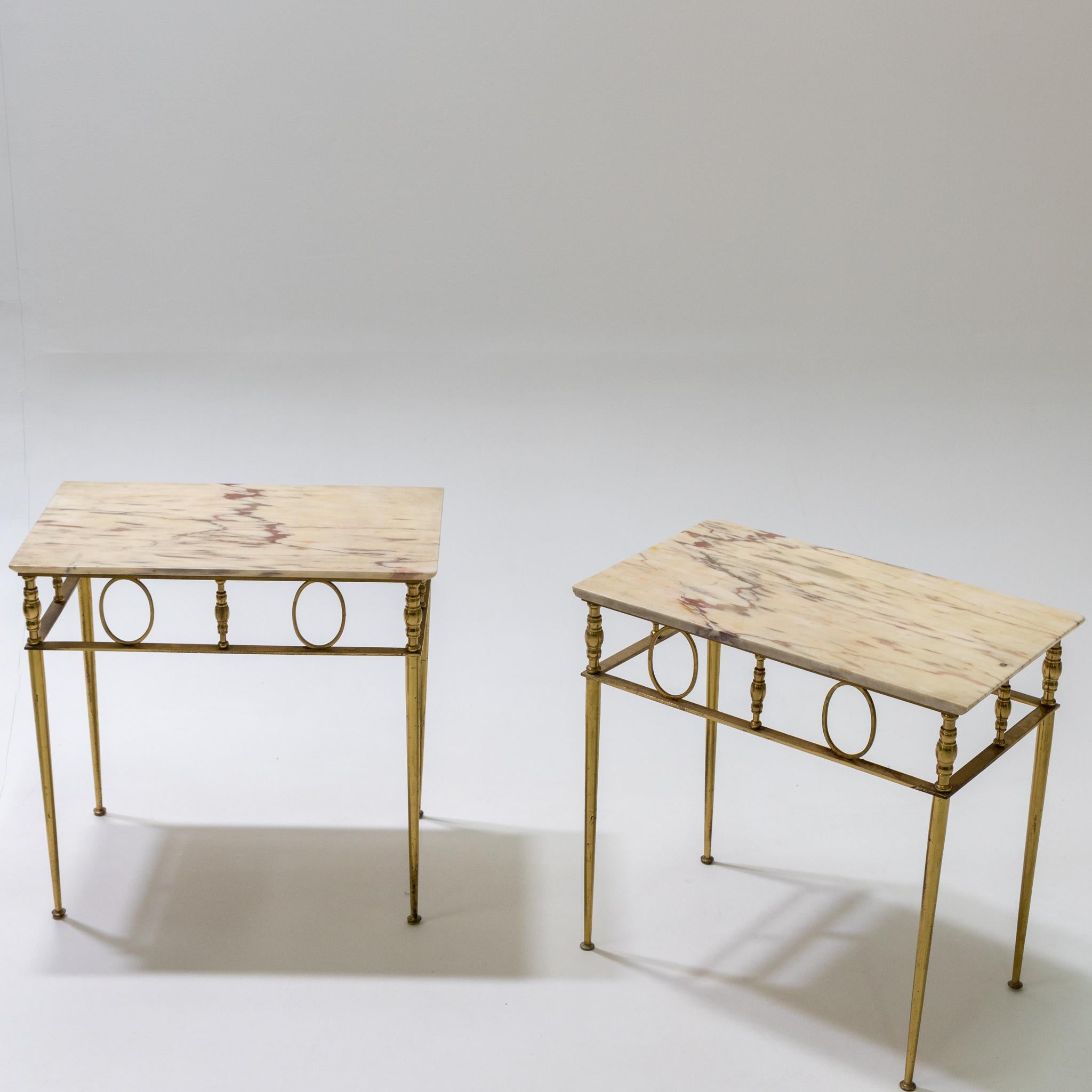 Pair of side tables with brass frames and beige stone tops.