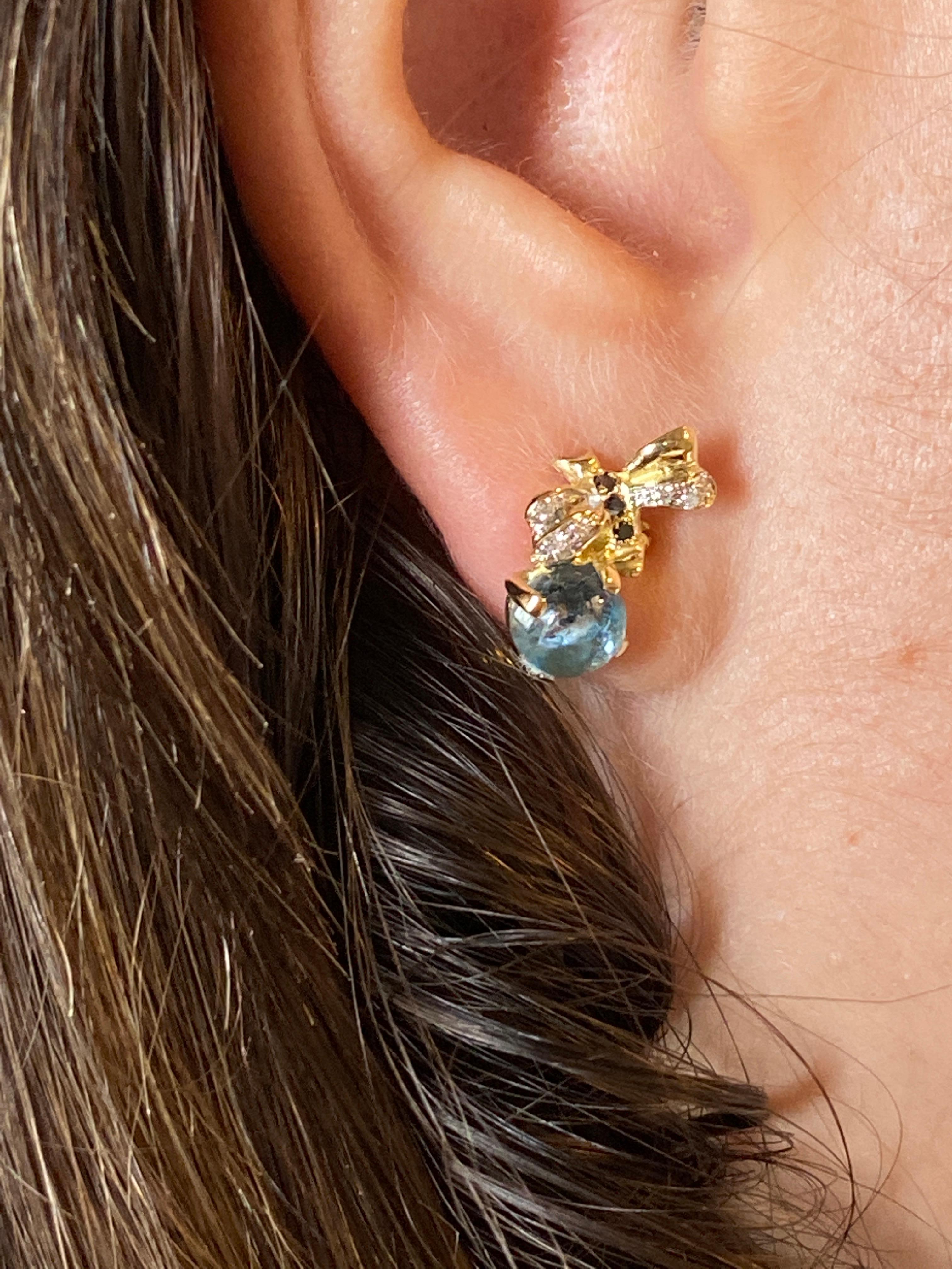Celebrate nature's intricate beauty with the Rossella Ugolini Design Collection, featuring enchanting 18 Karat Yellow Gold Bee Stud Earrings. Adorned with a captivating 2.16 Carat Aquamarine, alongside 0.10 Karats of White Diamonds and 0.06 Karats