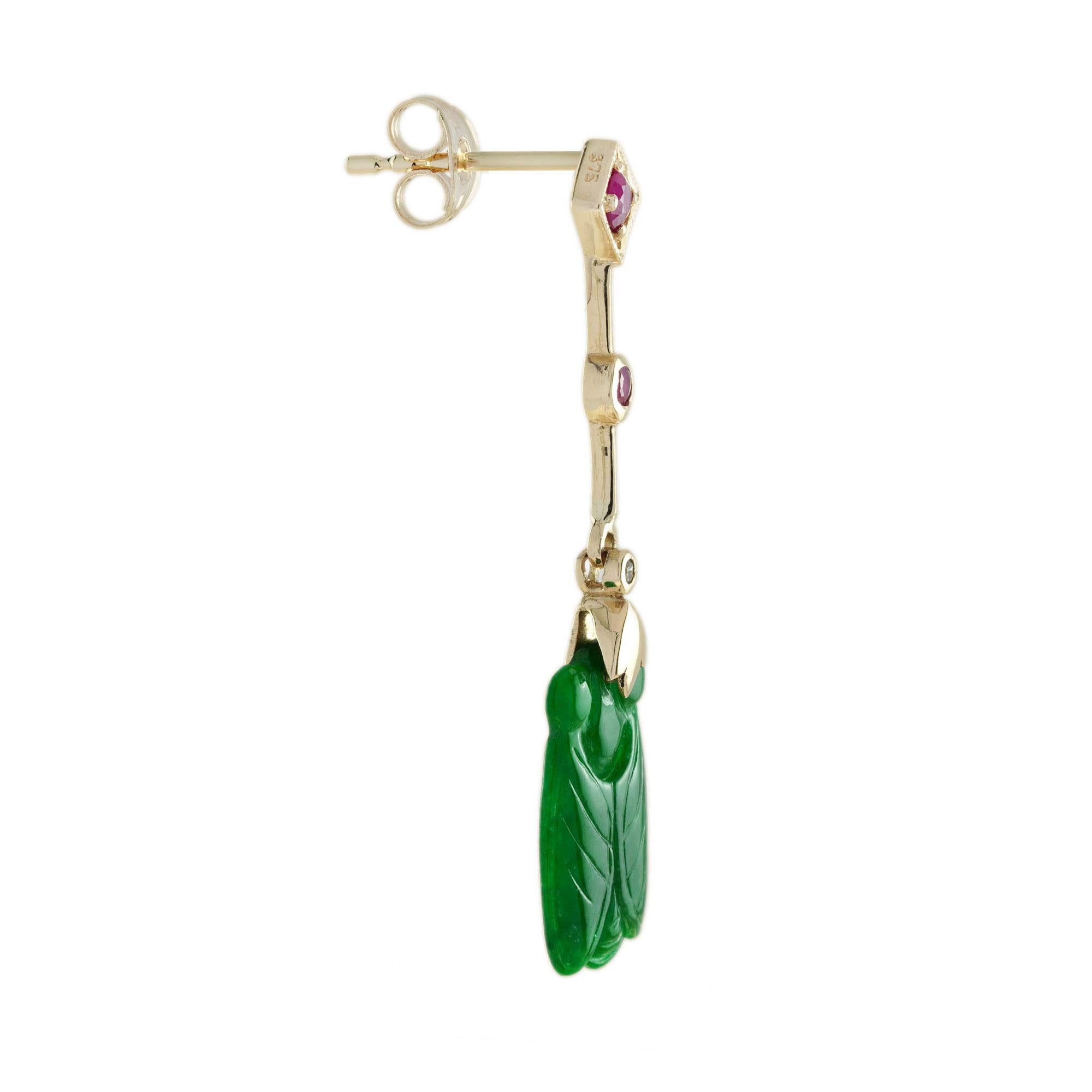 The natural jade in these lovely earrings has some very special shape. Both pieces have a strong green color and well bee carvings. The jade is suspended in a 9k yellow gold setting with ruby and diamond link on the top. The earrings transfer their