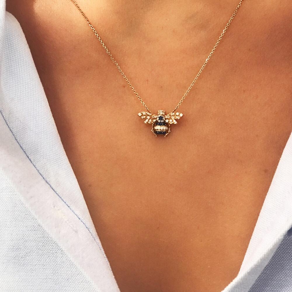 The Bee Necklace is a true emblem of feminine power. Inspired by the Queen Bee, it is an 
expression of purification, physical abundance and perfection. Set in 0.19 carat white diamonds and 0.11 carat sapphire, the Bee Necklace is 1 cm in height and